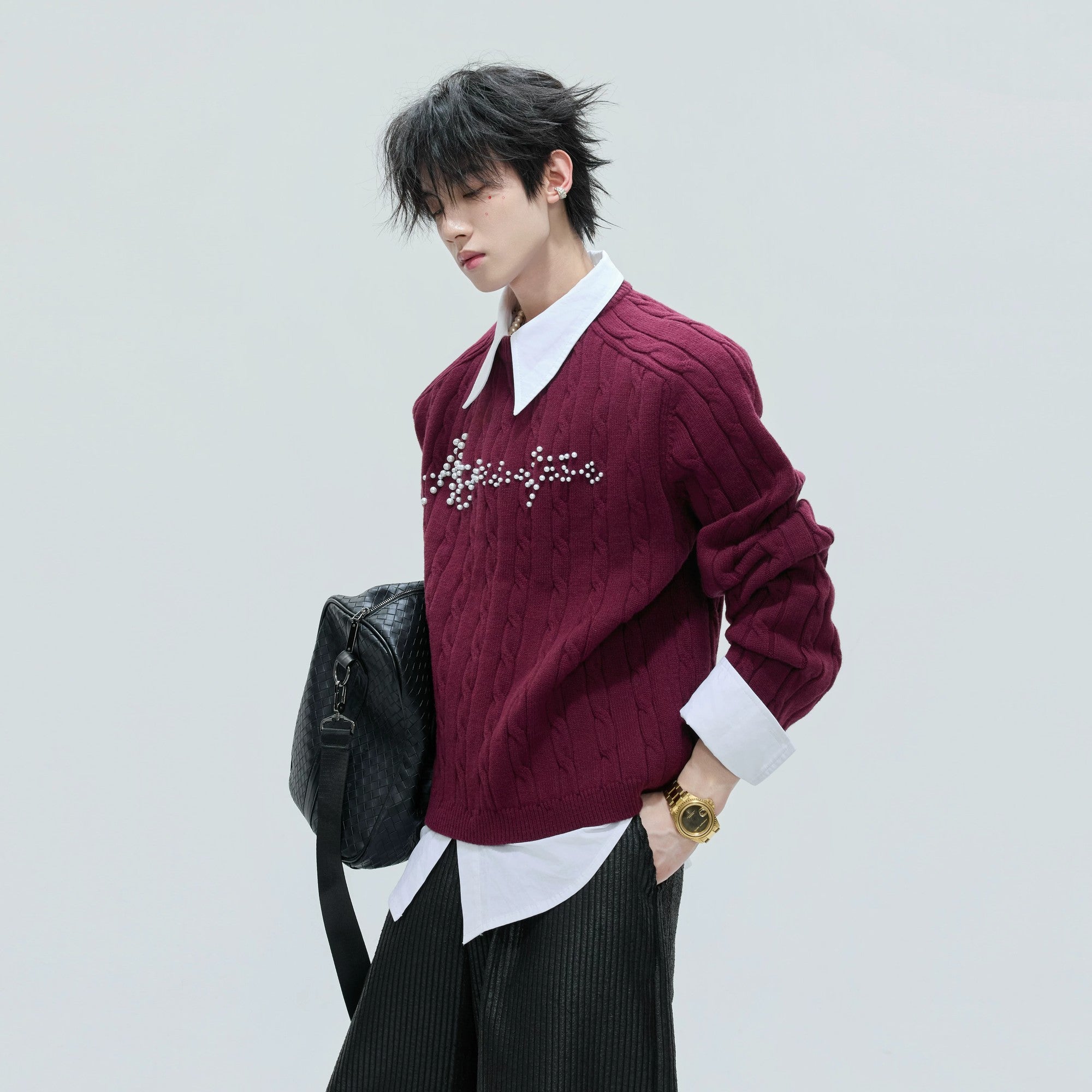 Model wearing khaki layered knit top in a street style setting