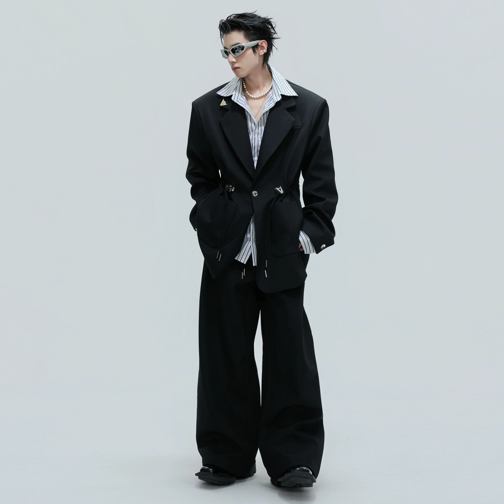 Detailed view of the built-in striped shirt cuffs and layered lapel design.