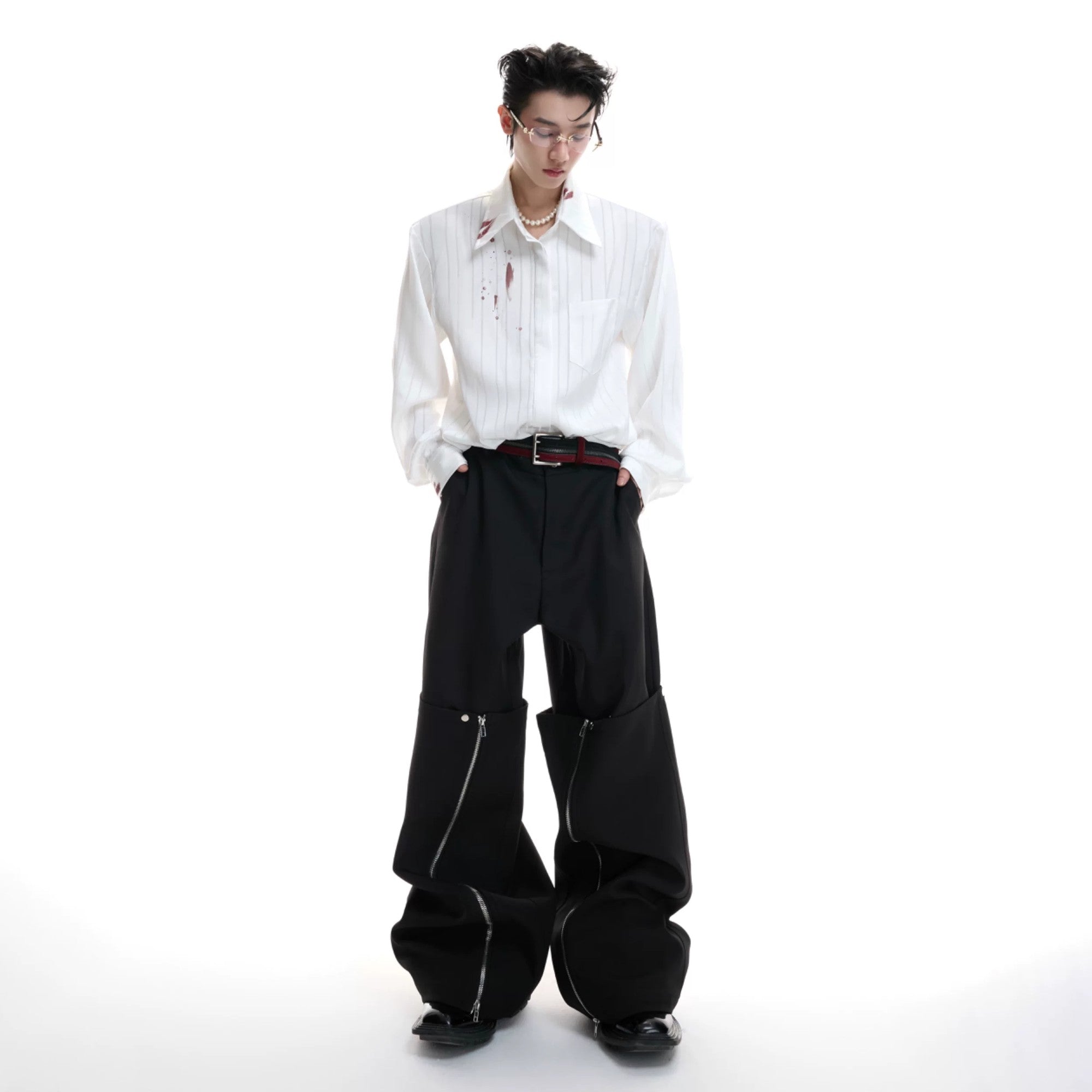 Male model wearing loose fit striped shirt with baggy jeans outfit