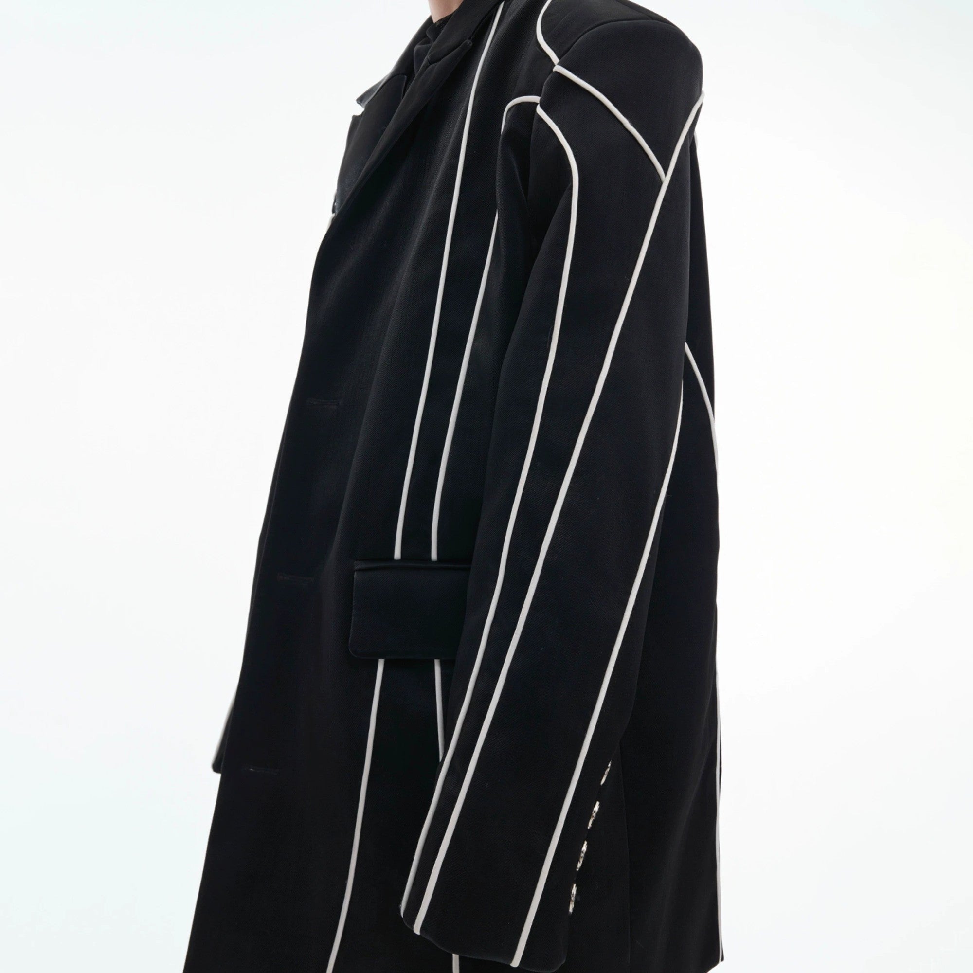Reflective design lines glowing on a black streetwear blazer