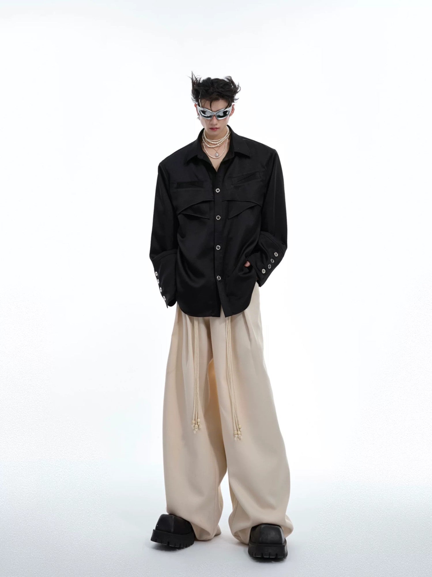 Male model wearing a deconstructed liquid texture shirt with accessories.