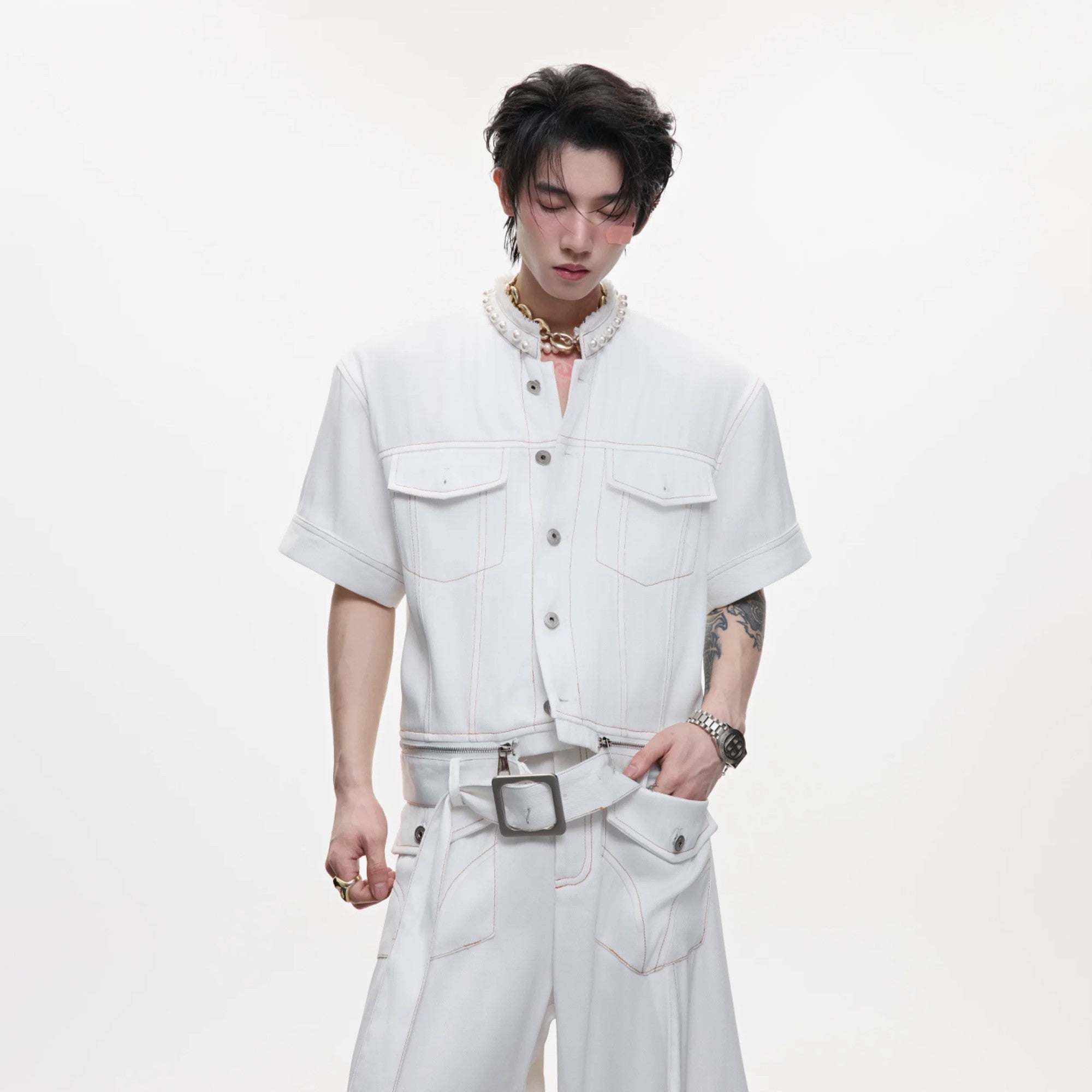 Male model wearing white pearl denim set in an urban streetwear setting