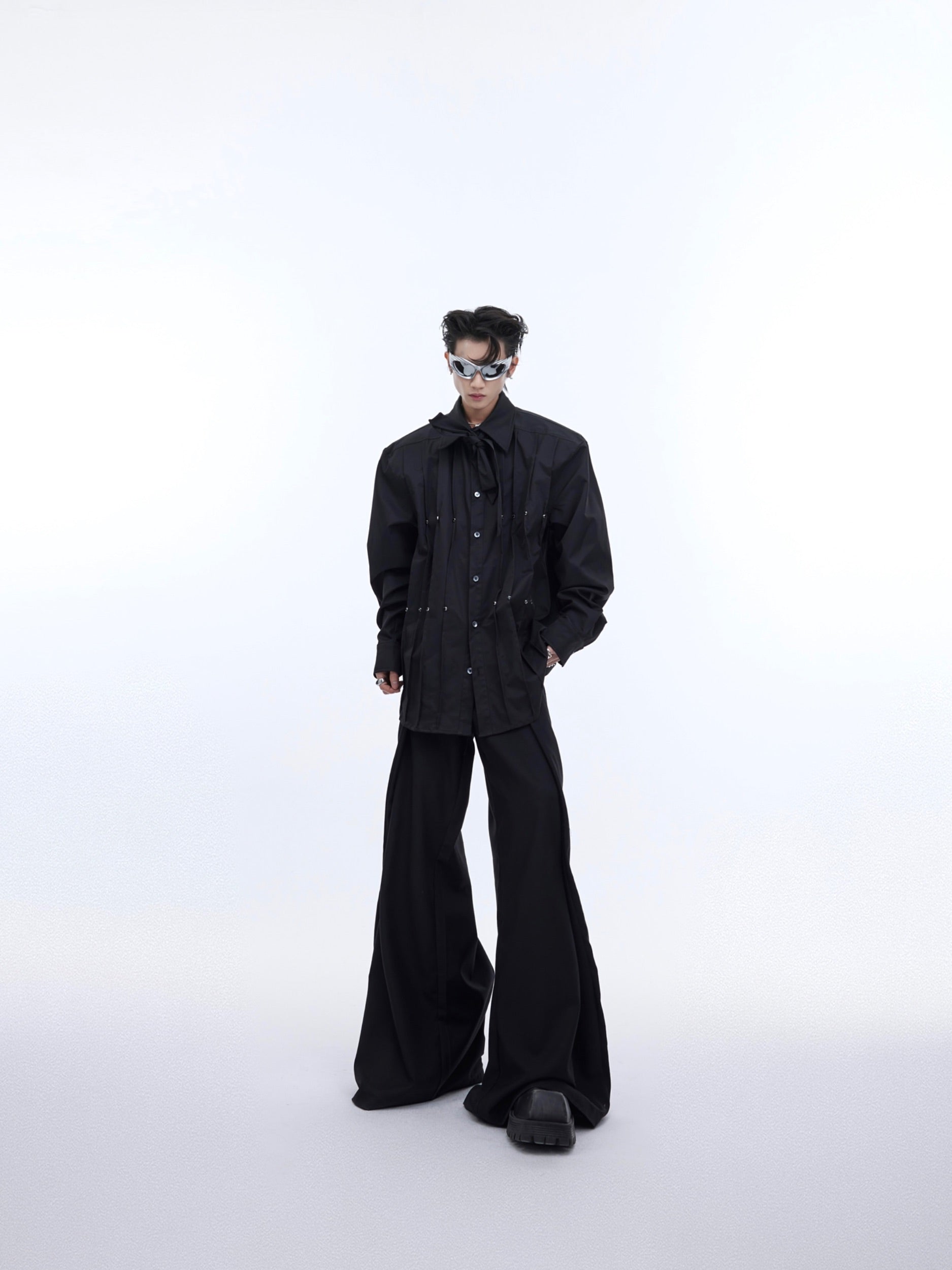 Back view of avant-garde white shirt featuring bold pleated details and modern streetwear silhouette