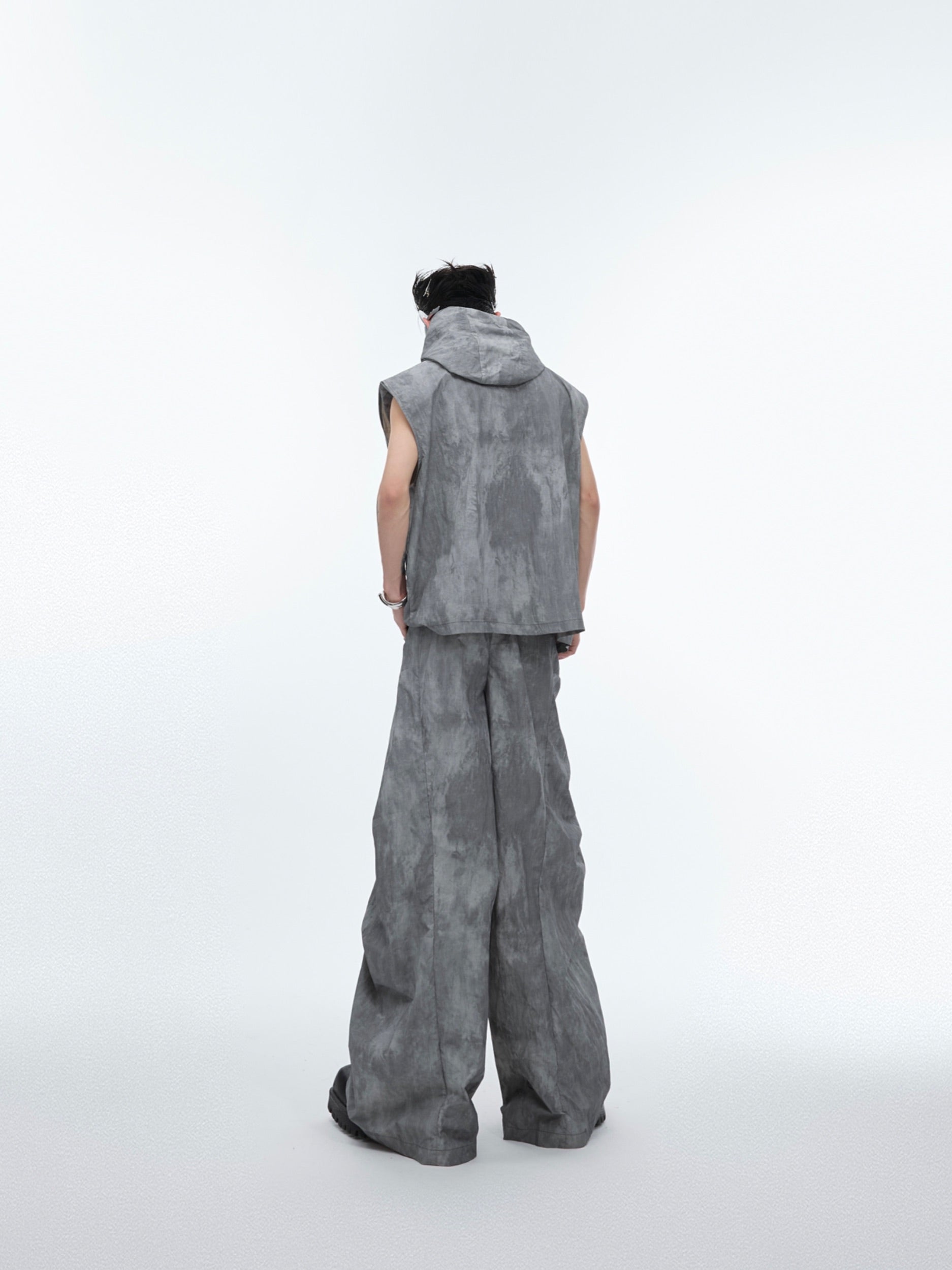 Front view showing detachable elements and asymmetric design of this deconstructed streetwear vest