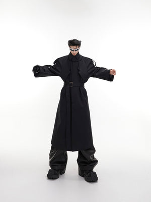 Detailed view of asymmetric hem on deconstructed longline trench coat, highlighting modern streetwear design elements
