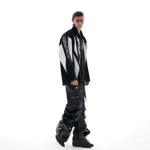 Detailed view of sleeve construction and color-block pattern on statement oversized shirt-jacket
