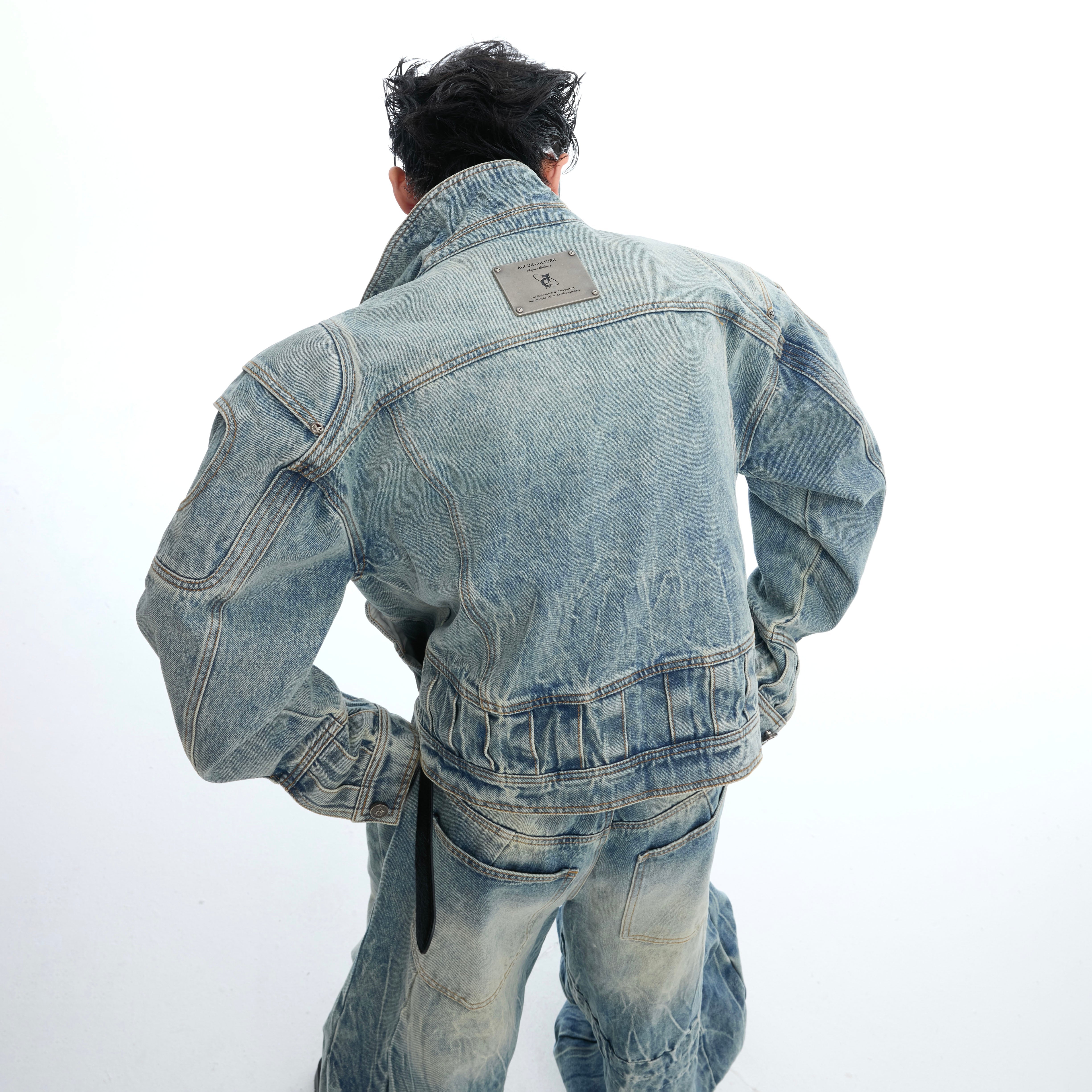 Front view of baggy distressed jeans featuring dramatic 3D pleating and armor-like structure