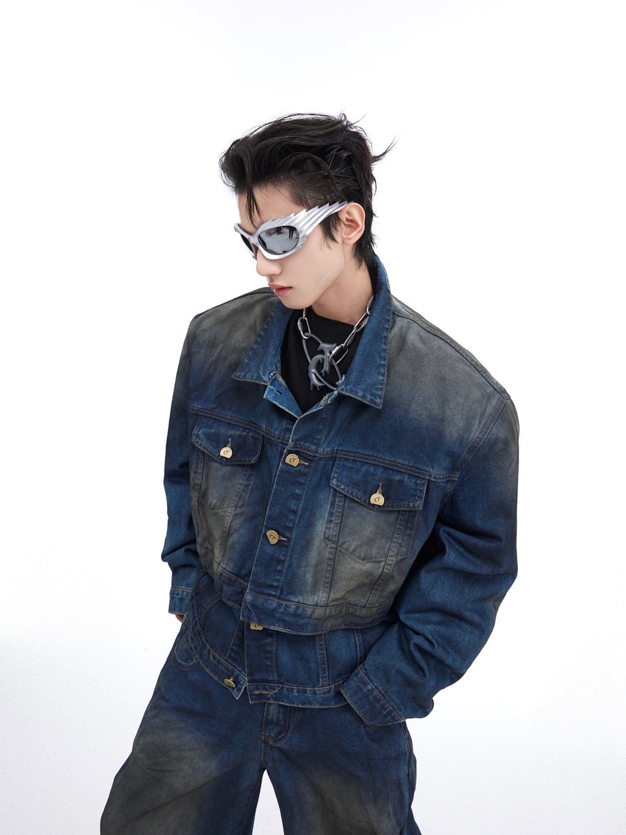 Distressed baggy denim pants with irregular fading and crinkled wash treatment for edgy streetwear look