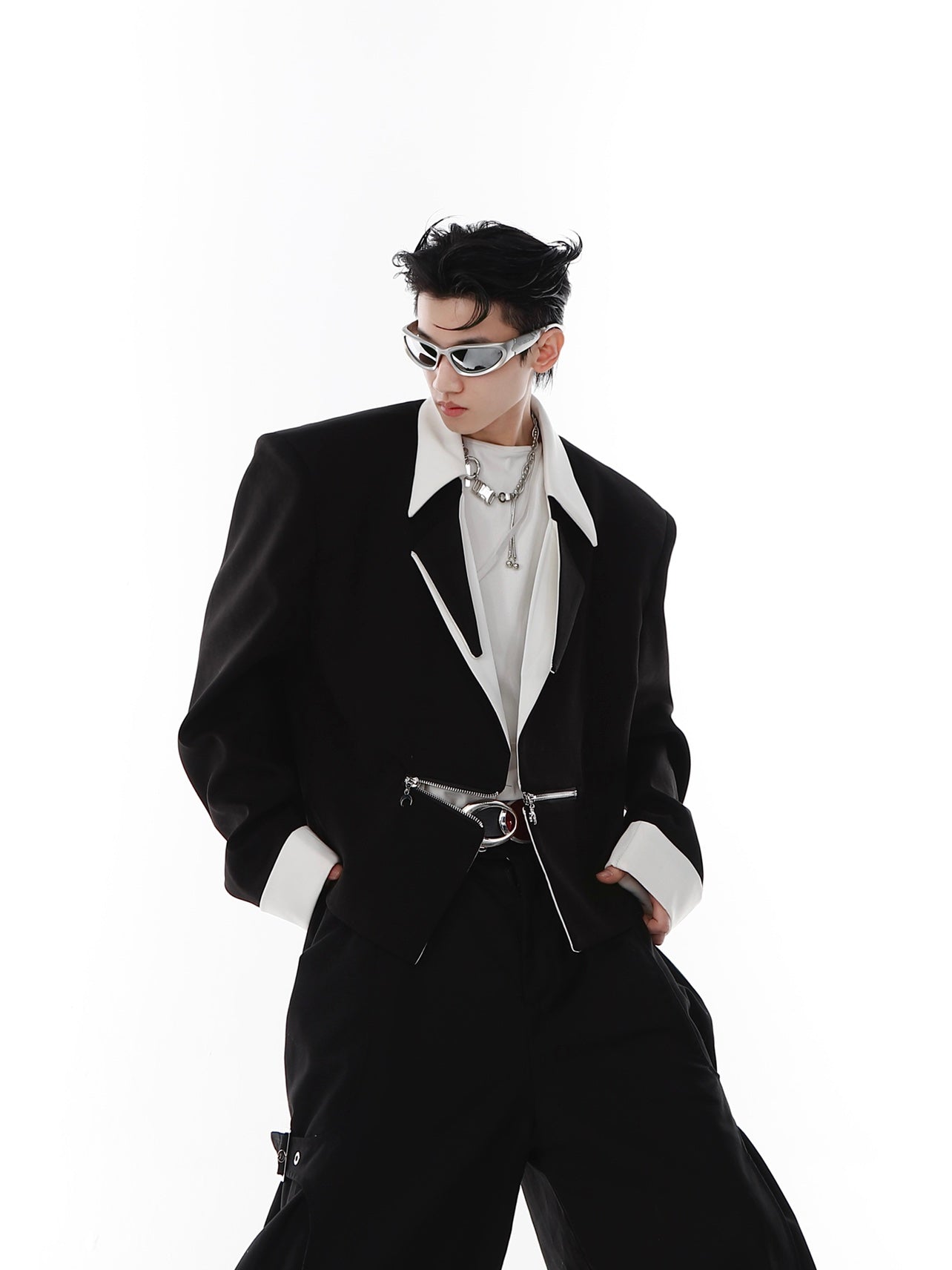 Detail shot highlighting the premium metallic zipper and hardware on this contemporary unisex cropped jacket