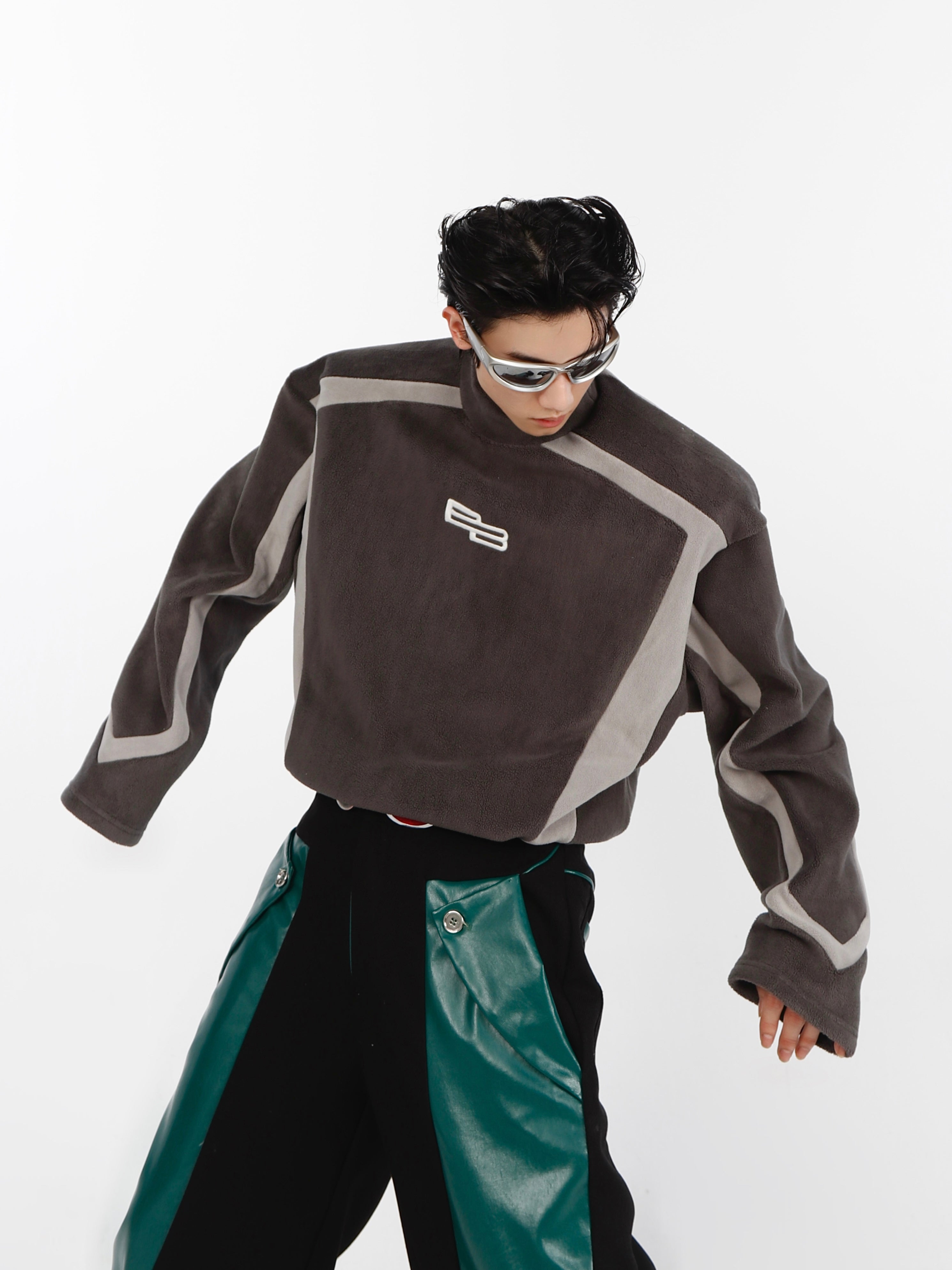 Close-up of statement embroidery detail on gender-neutral avant-garde streetwear hoodie with panel construction