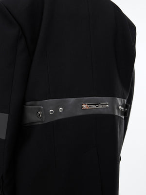 Side profile of avant-garde streetwear blazer showcasing equestrian-inspired lines and dimensional pleating