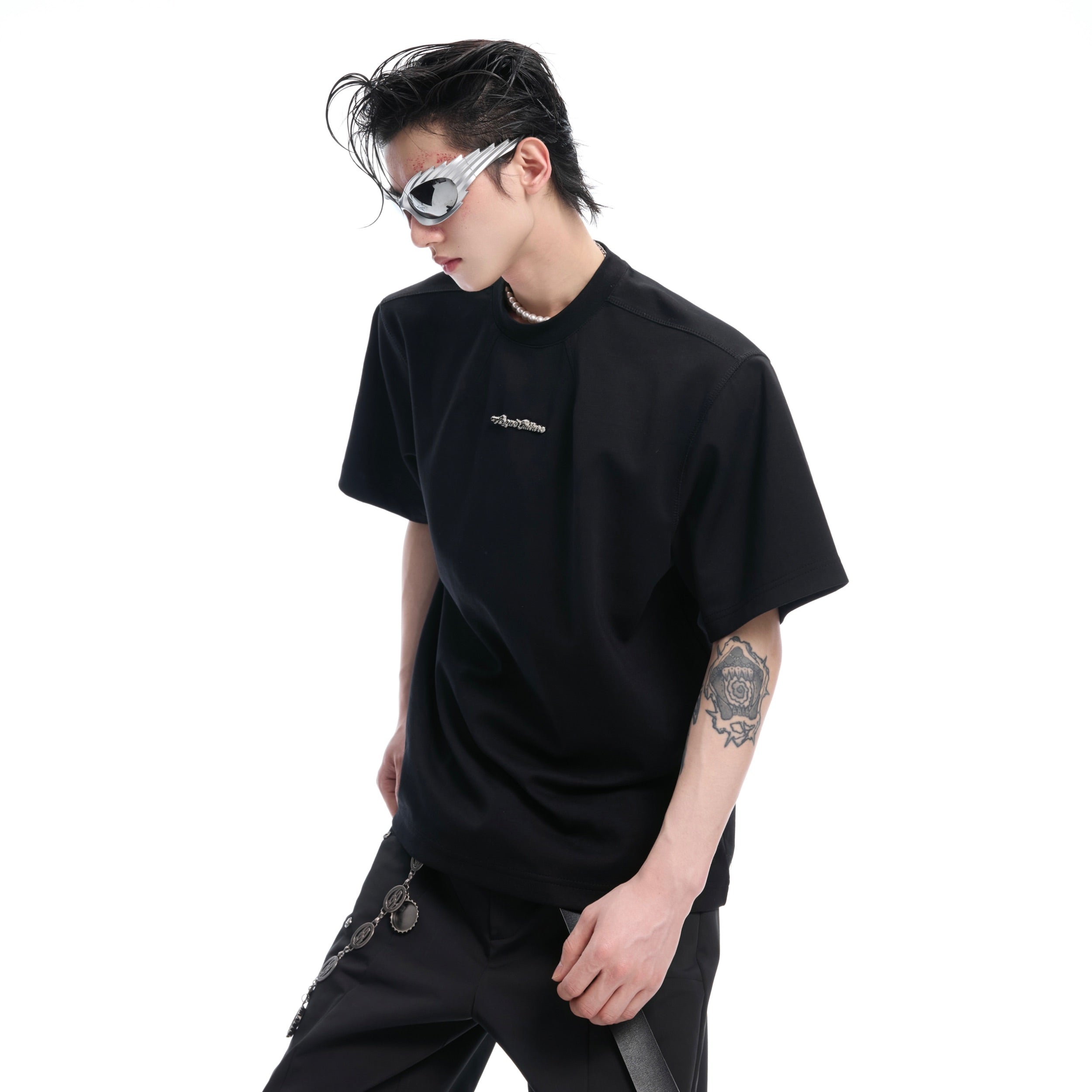 Close-up of premium boxy fit t-shirt showing cutting-edge metal accents and craftsmanship details