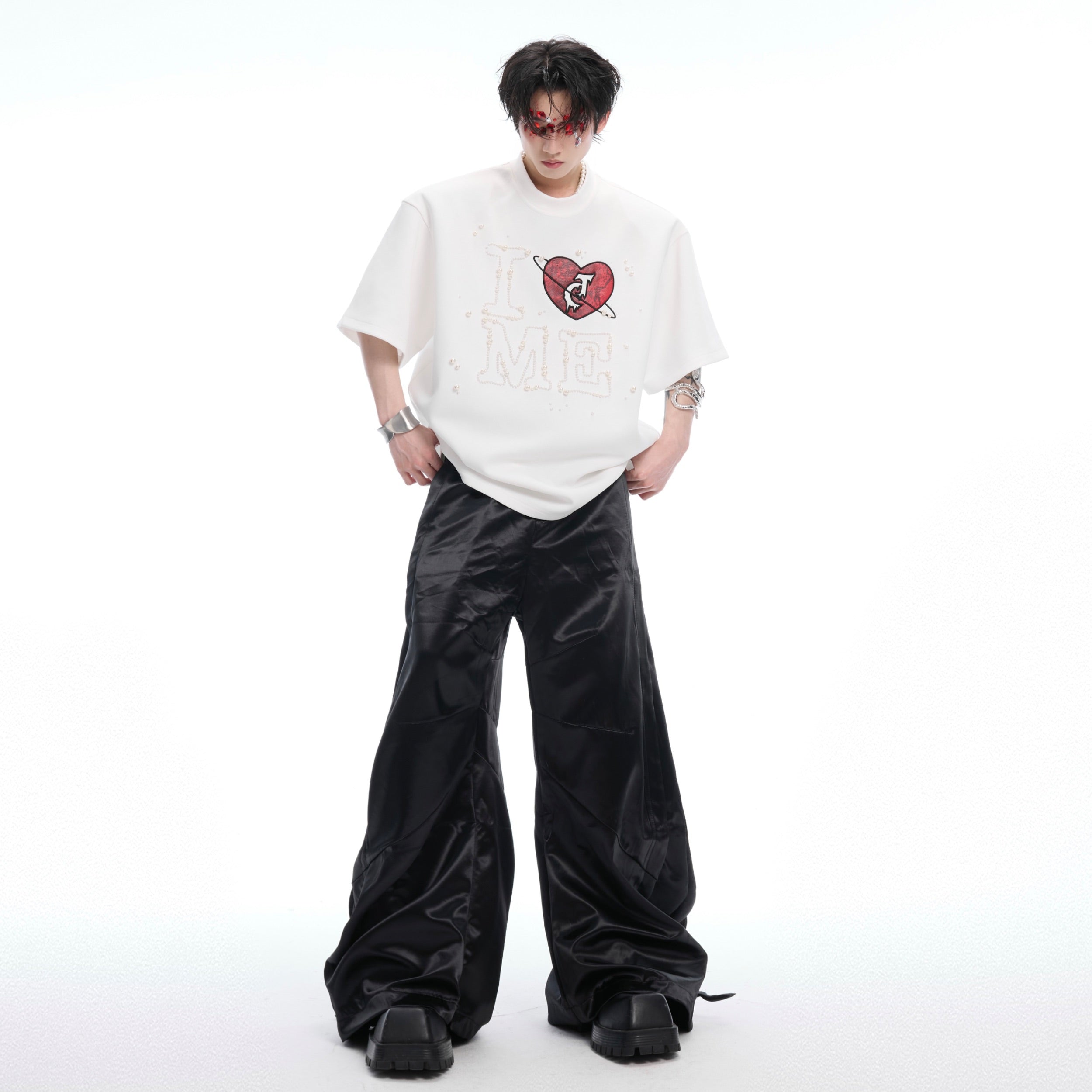 Model wearing comfortable oversized graphic tee with pearl heart details in street style