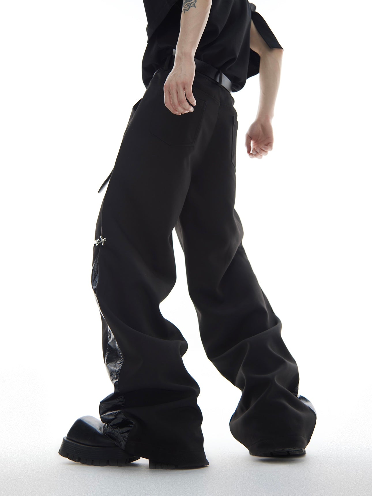 Close-up of detachable airplane buckles on stylish urban cargo pants with military-inspired details