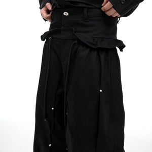 Close-up detail shot of the metal studs and heavy cotton fabric on these avant-garde cargo pants