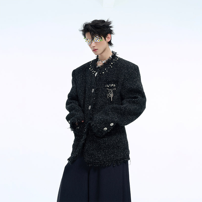Close-up of delicate pearl embellishments on the stylish tweed jacket collar and cuffs
