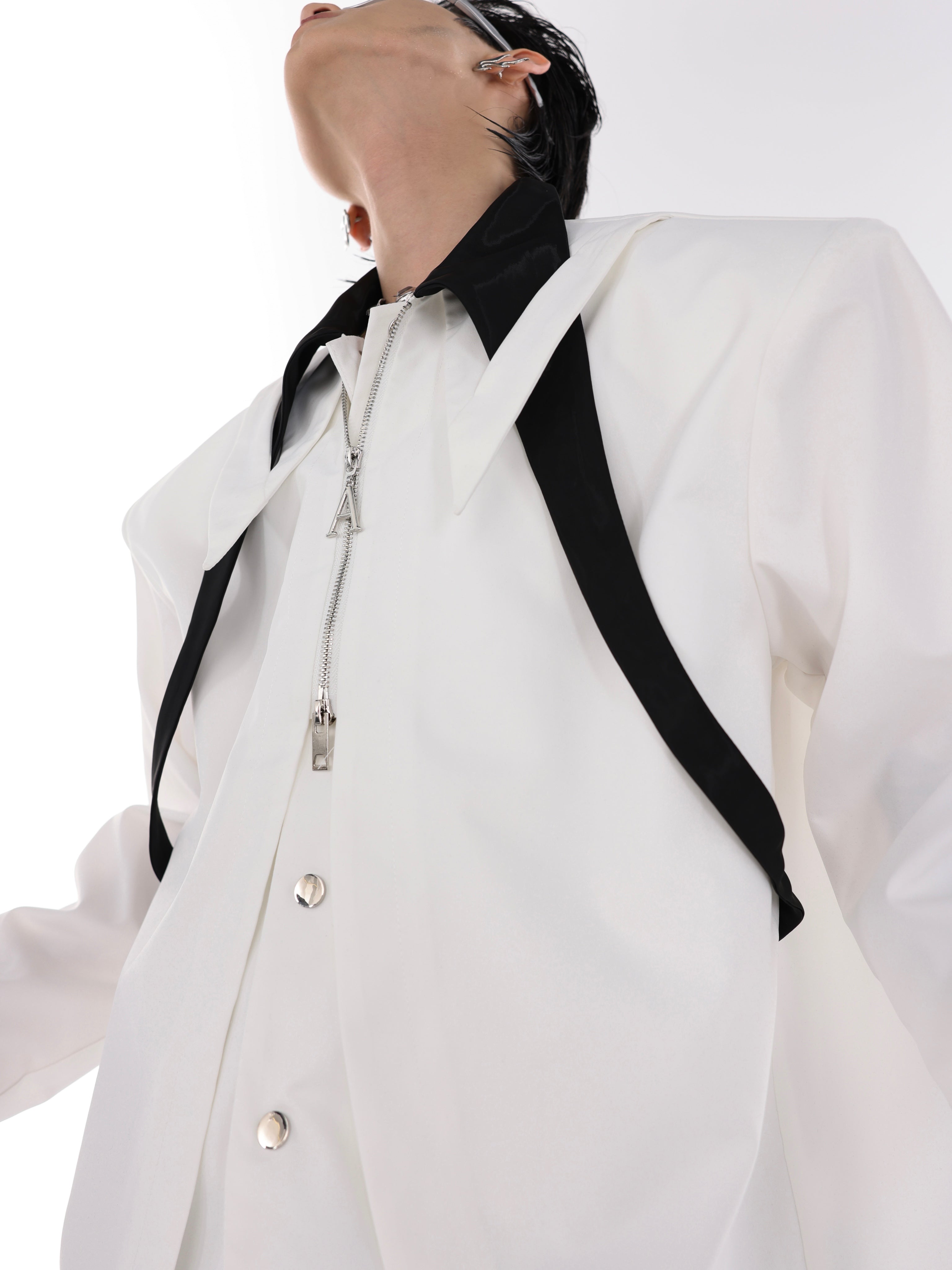 Deconstructed color-block shirt displaying the innovative extended tie that runs through the split collar design