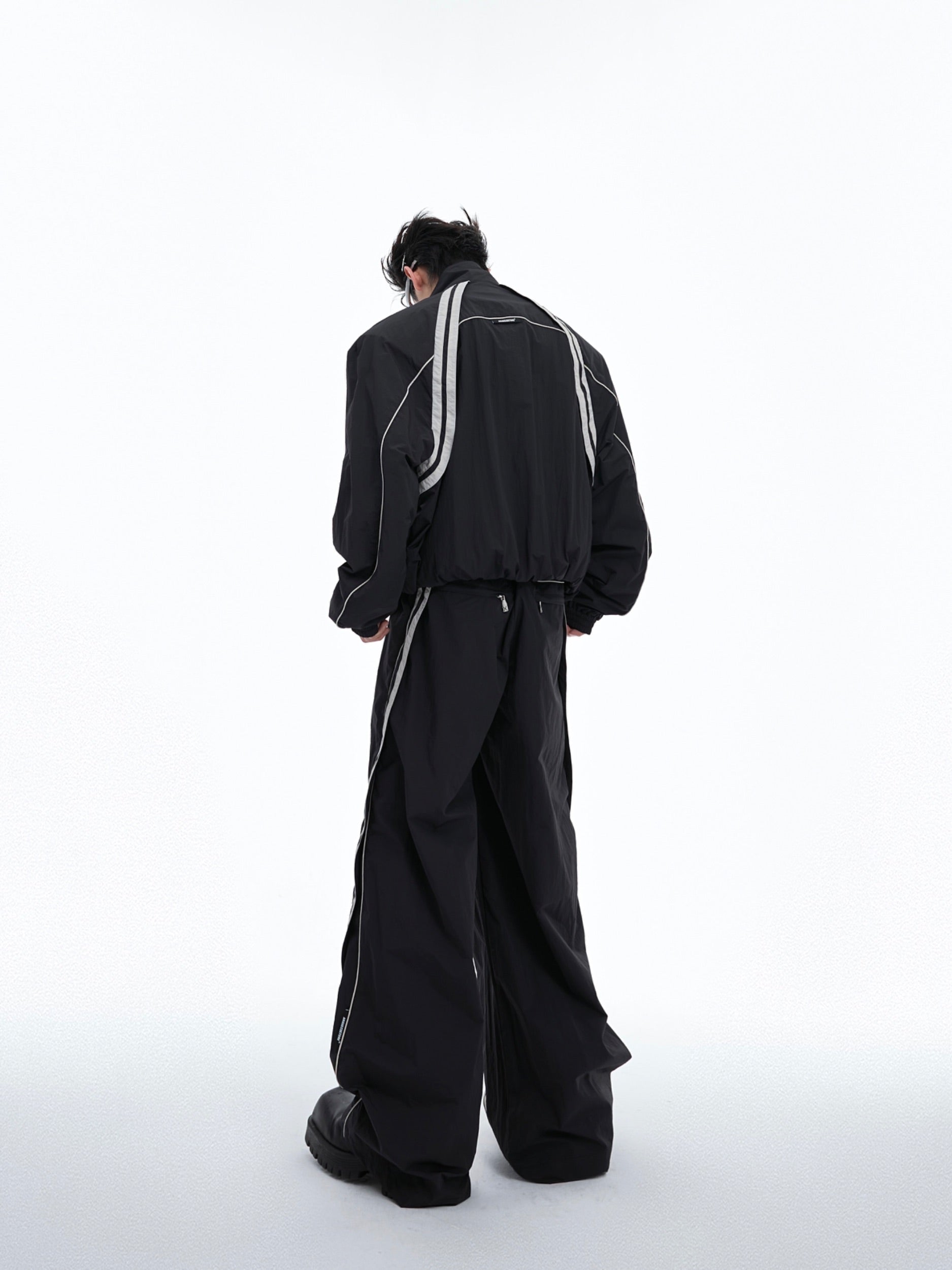 Detail shot of color-block hoodie showing unique raw-edged detailing and avant-garde construction
