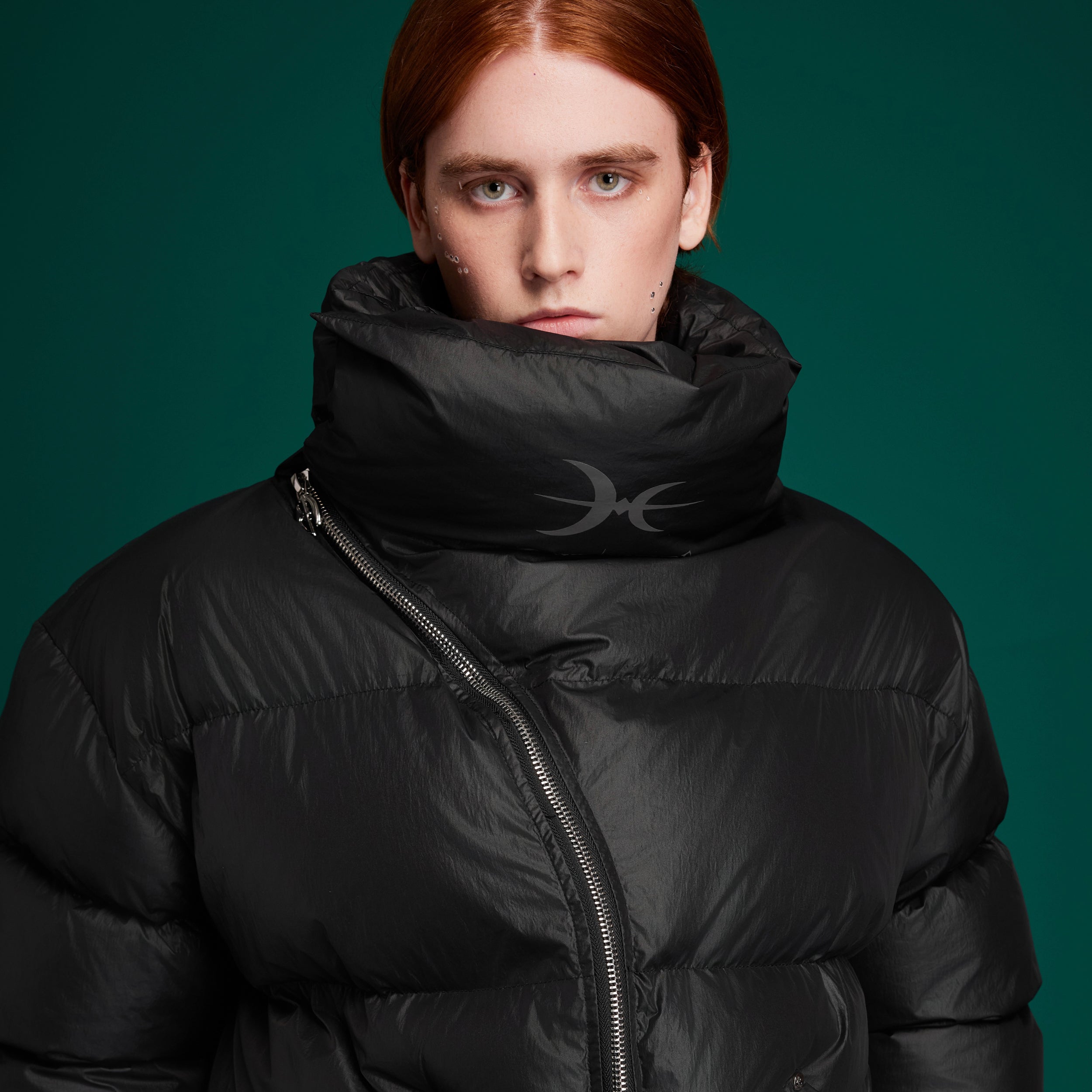 Stylish model wearing the oversized high-neck puffer jacket with diagonal zipper in urban setting