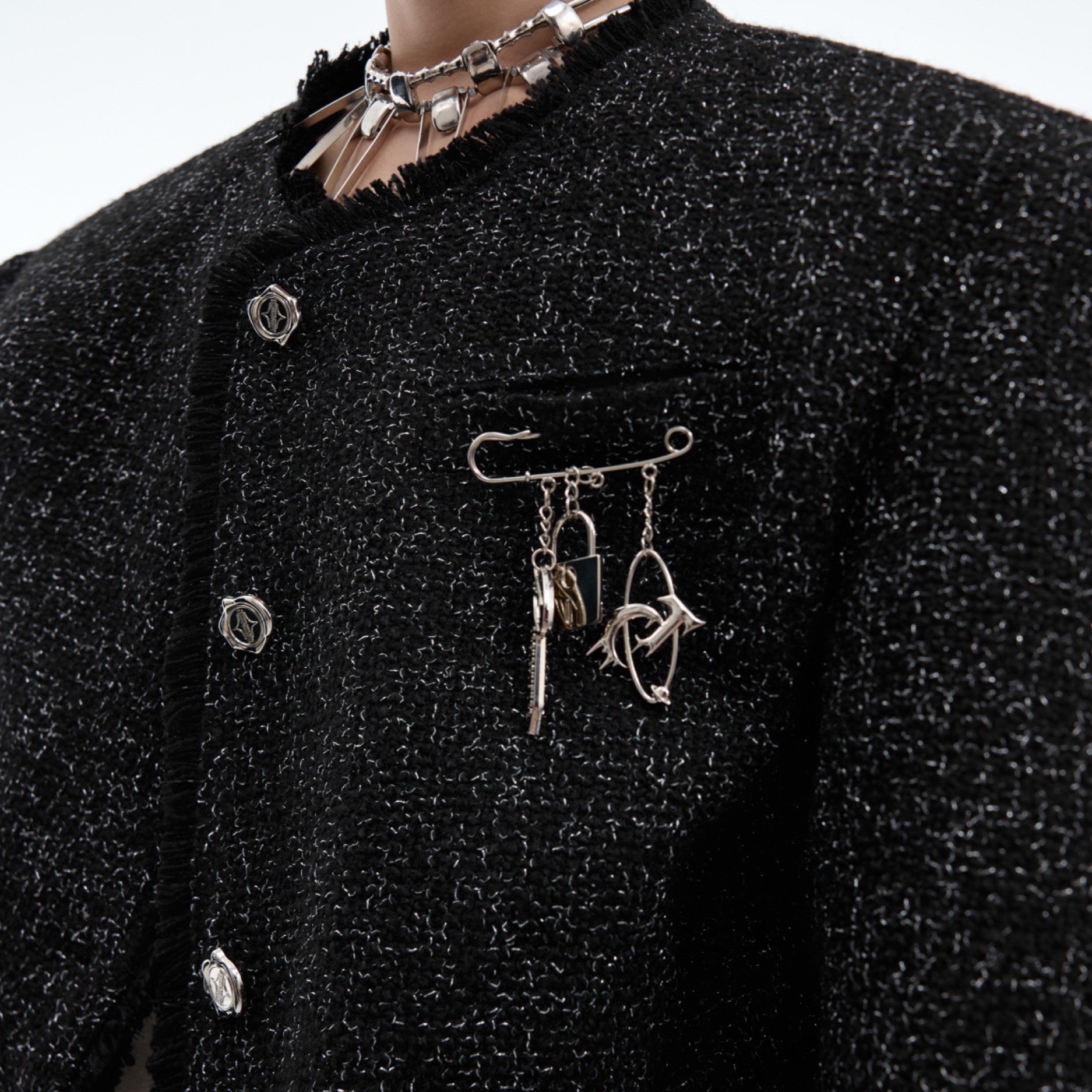 Side profile of stylish cropped coat featuring asymmetric design and structured fit
