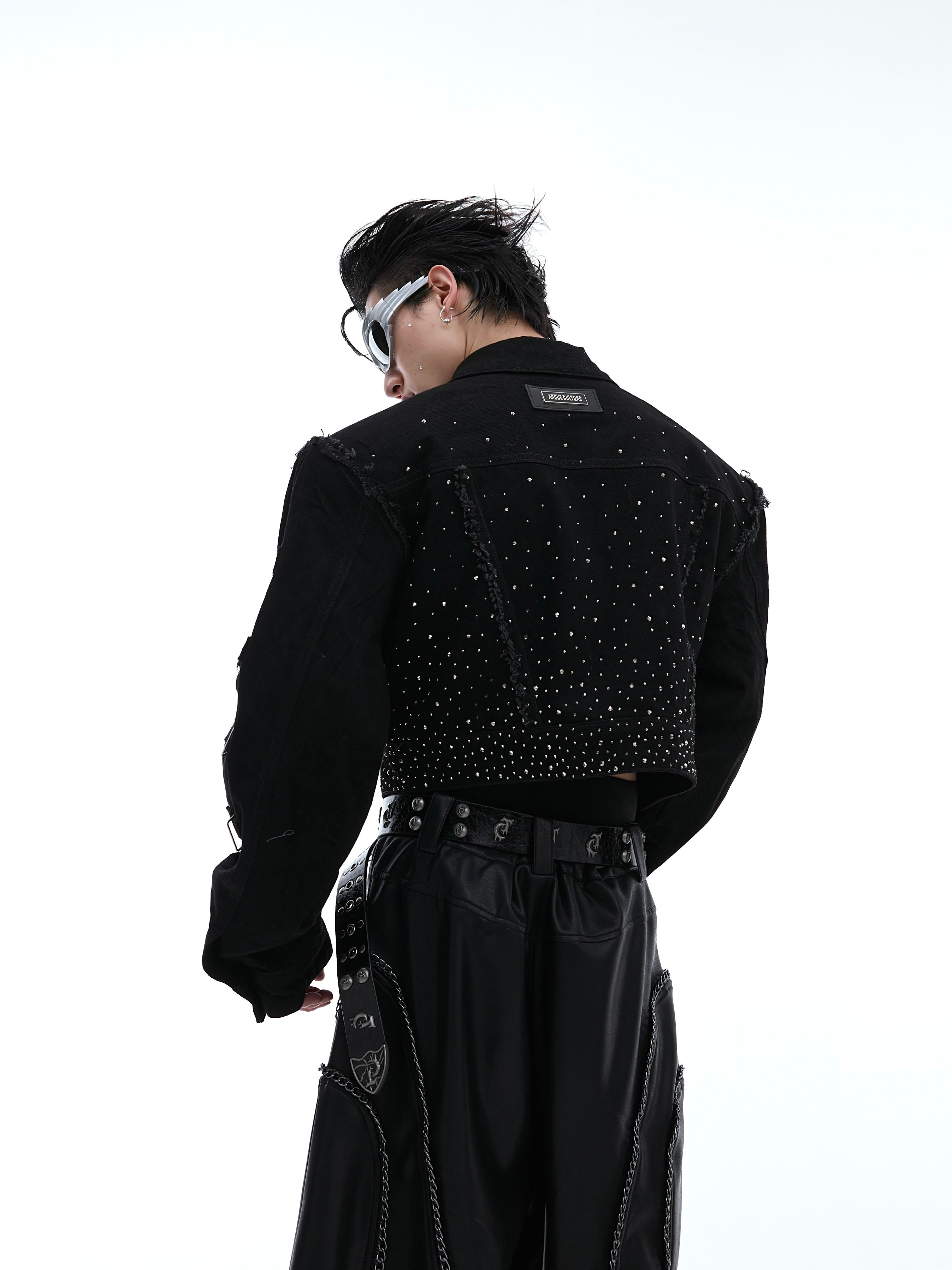 Back view showing unique deconstructed stitching and cropped silhouette of this fashion-forward denim jacket