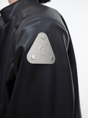Fashion model wearing the edgy cropped leather jacket with metal accents for street style