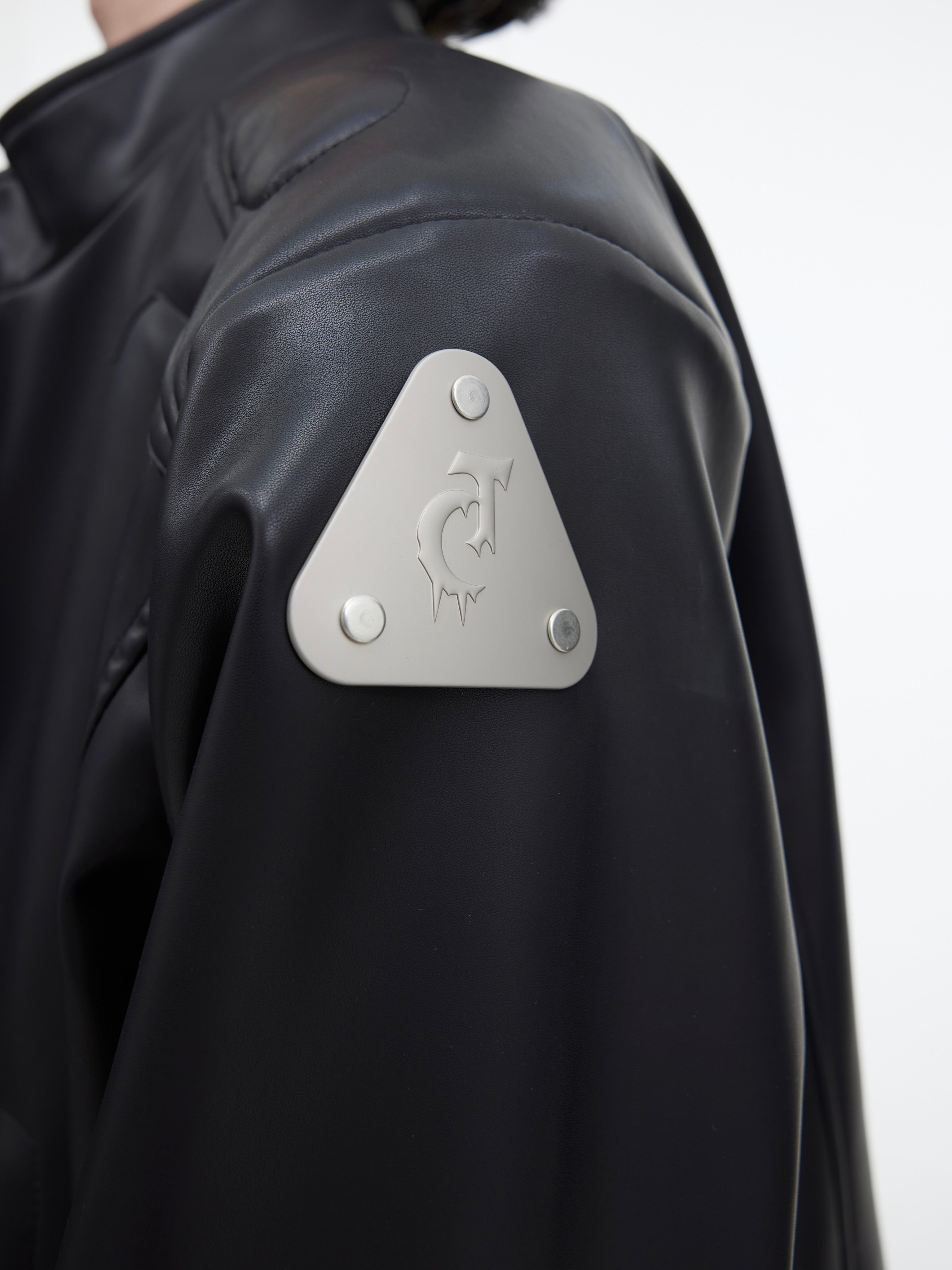 Fashion model wearing the edgy cropped leather jacket with metal accents for street style