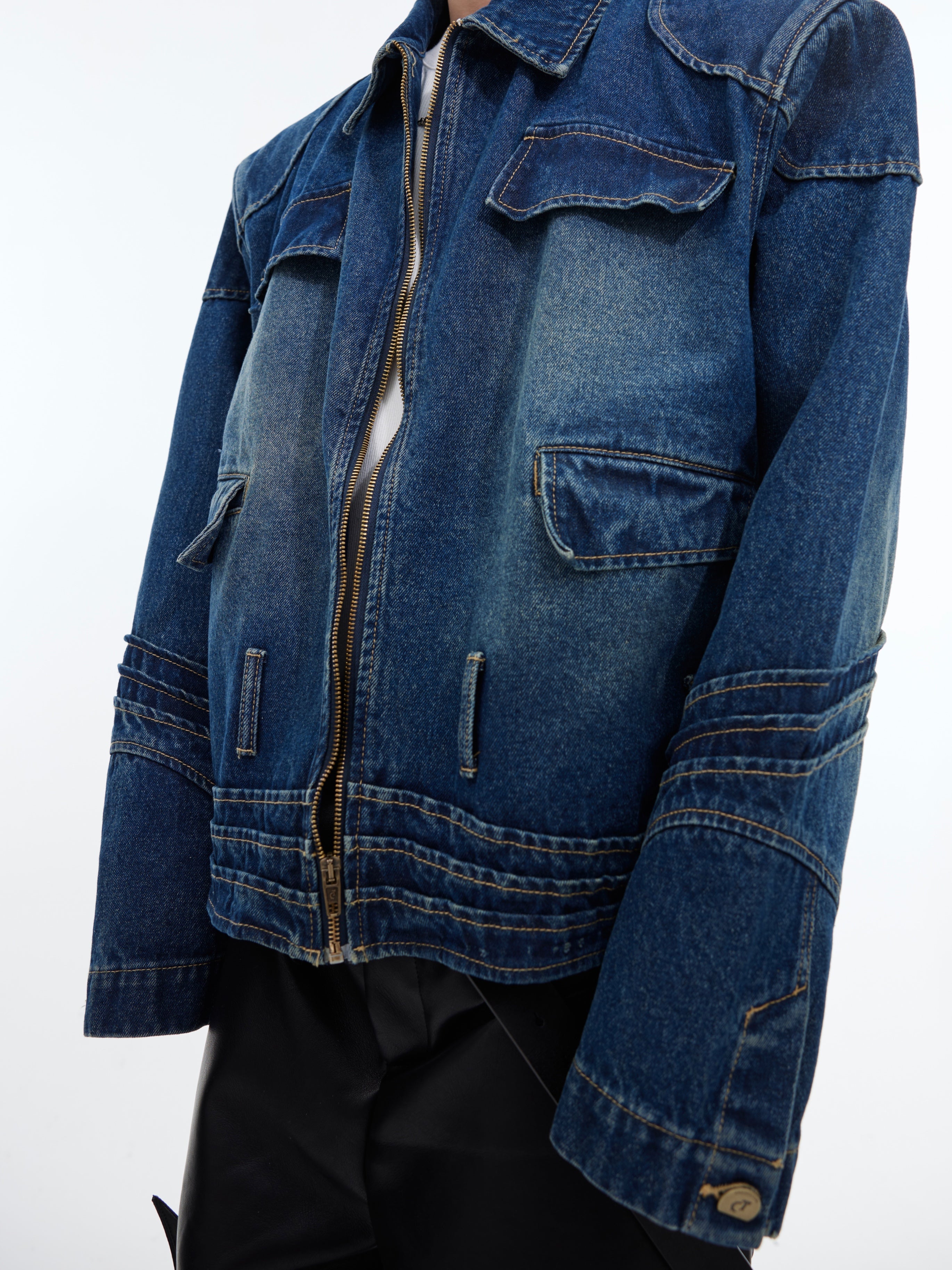Back view showcasing unique deconstructed design elements of this fashion-forward denim jacket