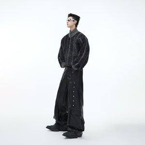 Back view of fashion model wearing statement silver glitter knit coat with high neck design