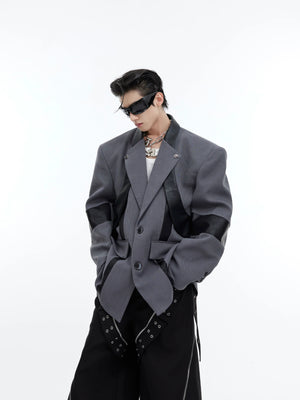 Front view of deconstructed shoulder-pad blazer with metallic detailing, showing asymmetrical patchwork design