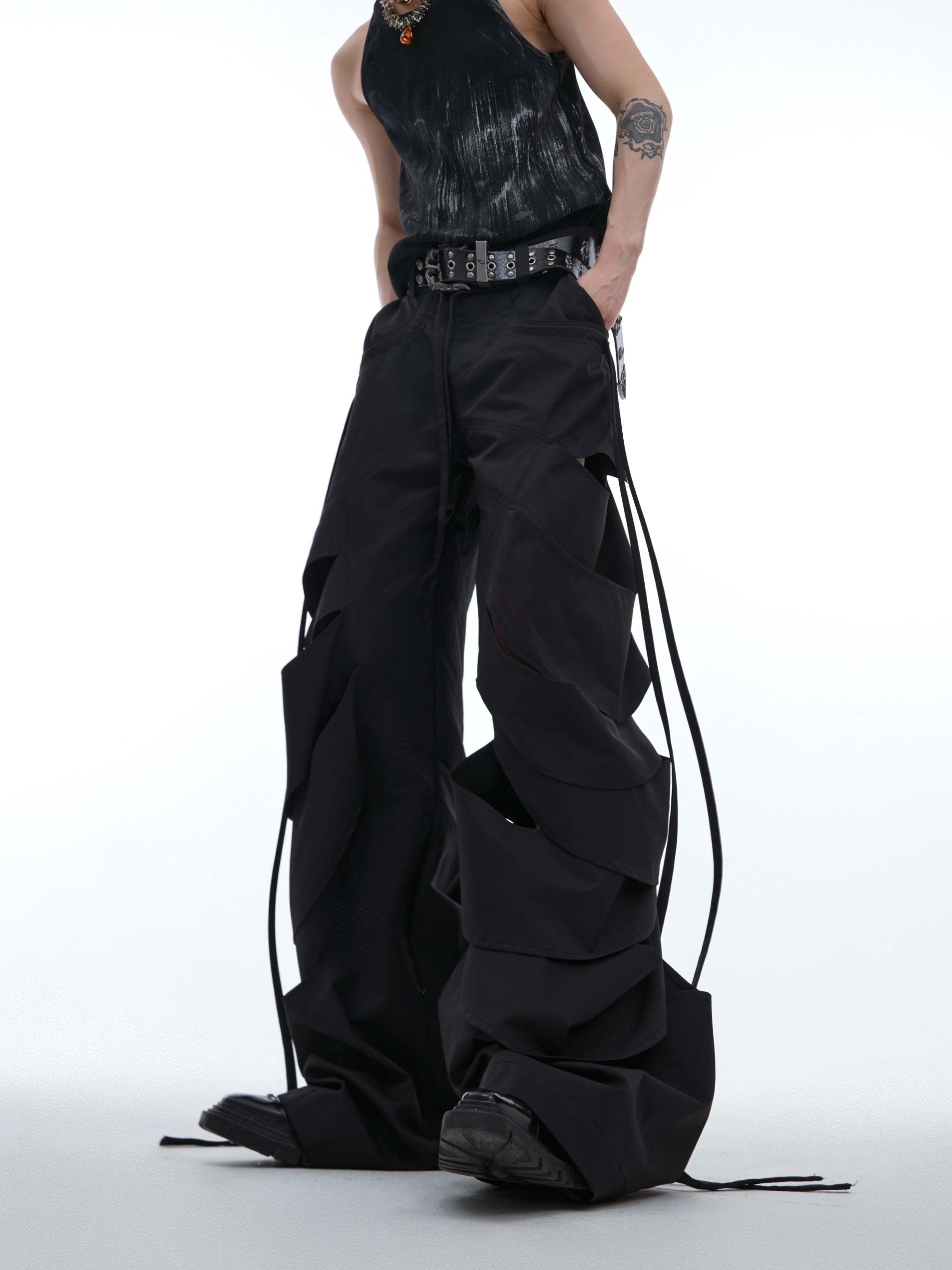 Deconstructed cargo pants with asymmetrical pleats and flowing ribbon accents, a unique streetwear statement piece