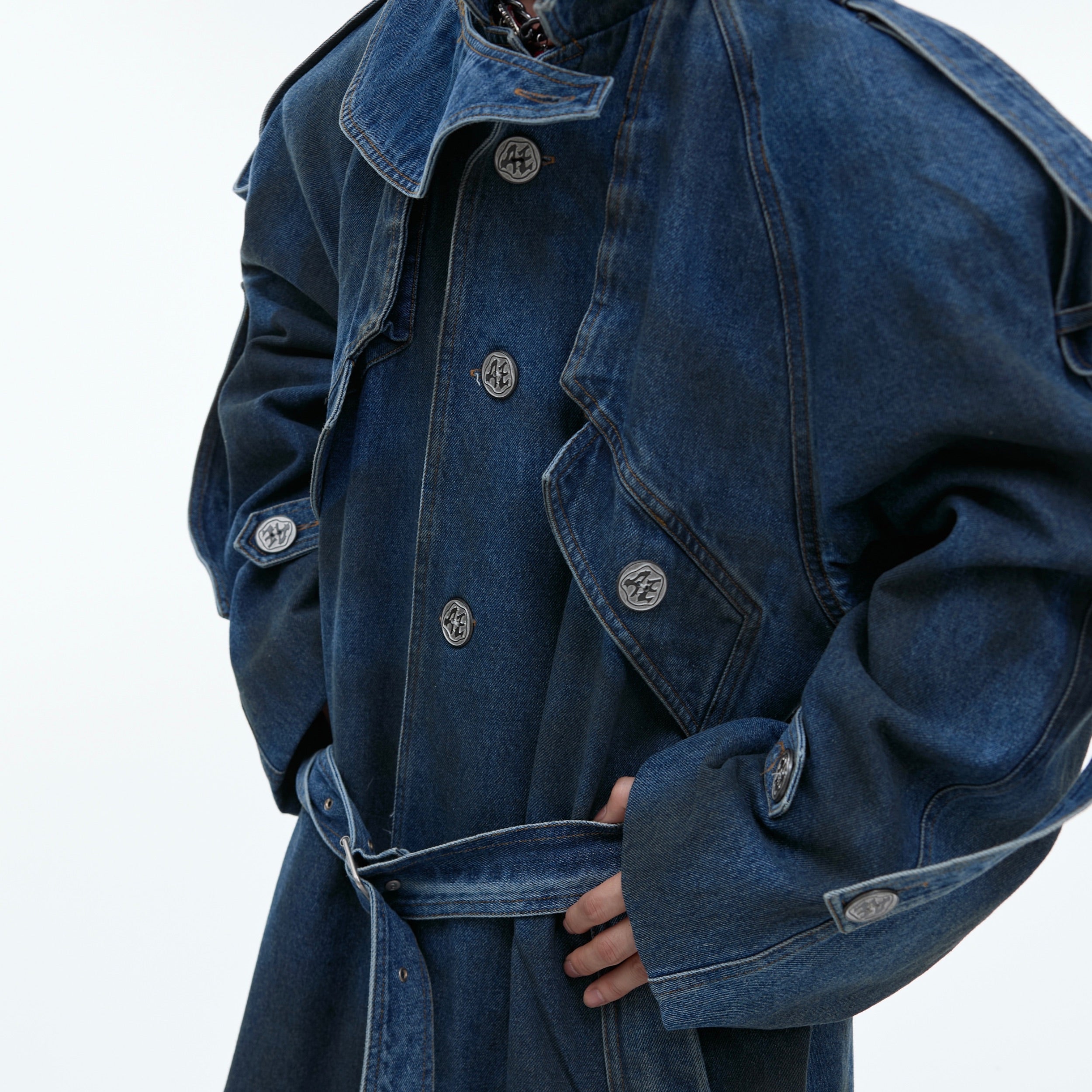 Deconstructed denim coat showing rigid yet breathable fabric construction and drape