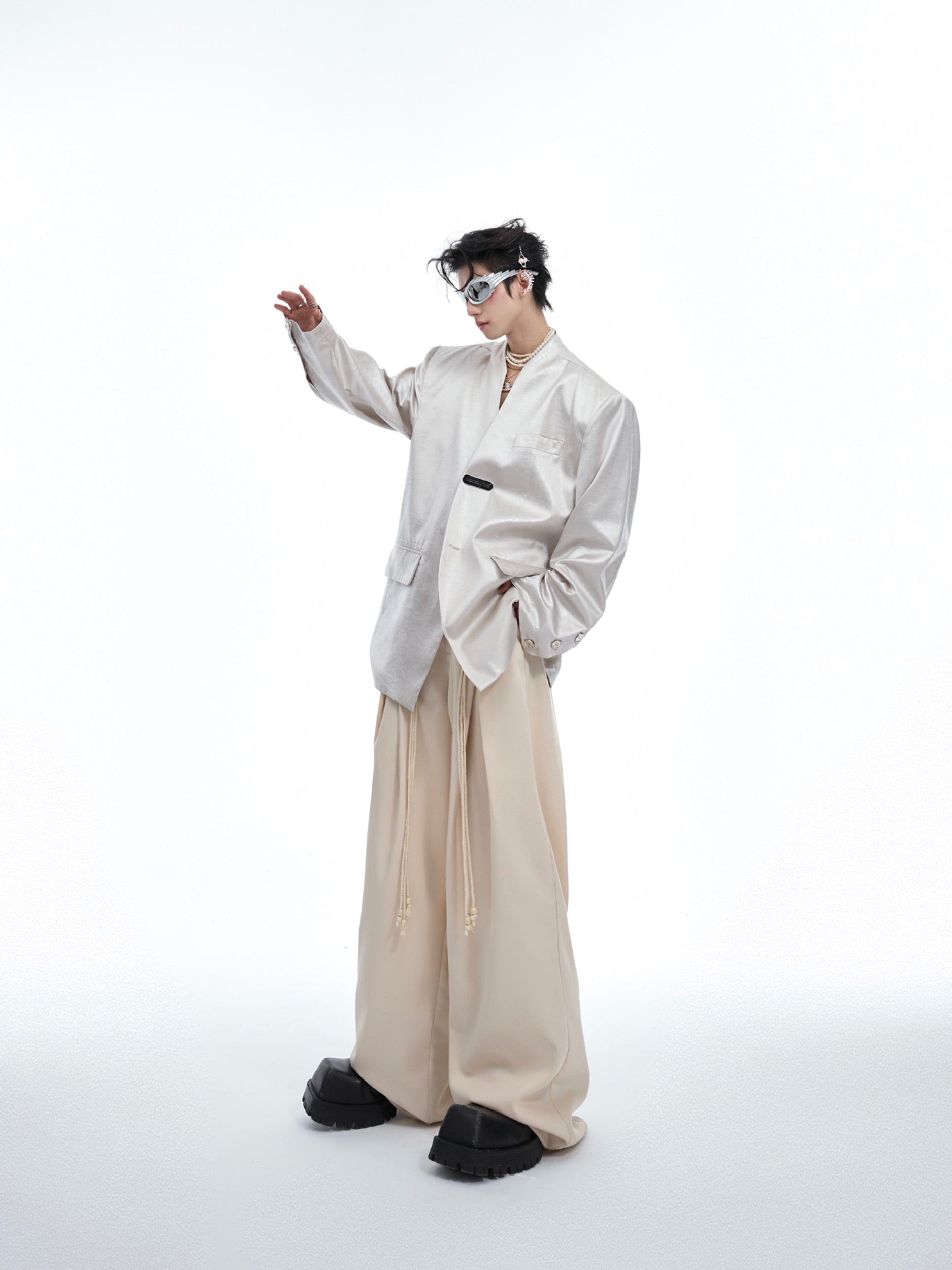 Draped styling of liquid metal textured blazer showing its deconstructed luxury design and urban edge