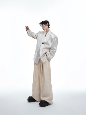 Draped styling of liquid metal textured blazer showing its deconstructed luxury design and urban edge
