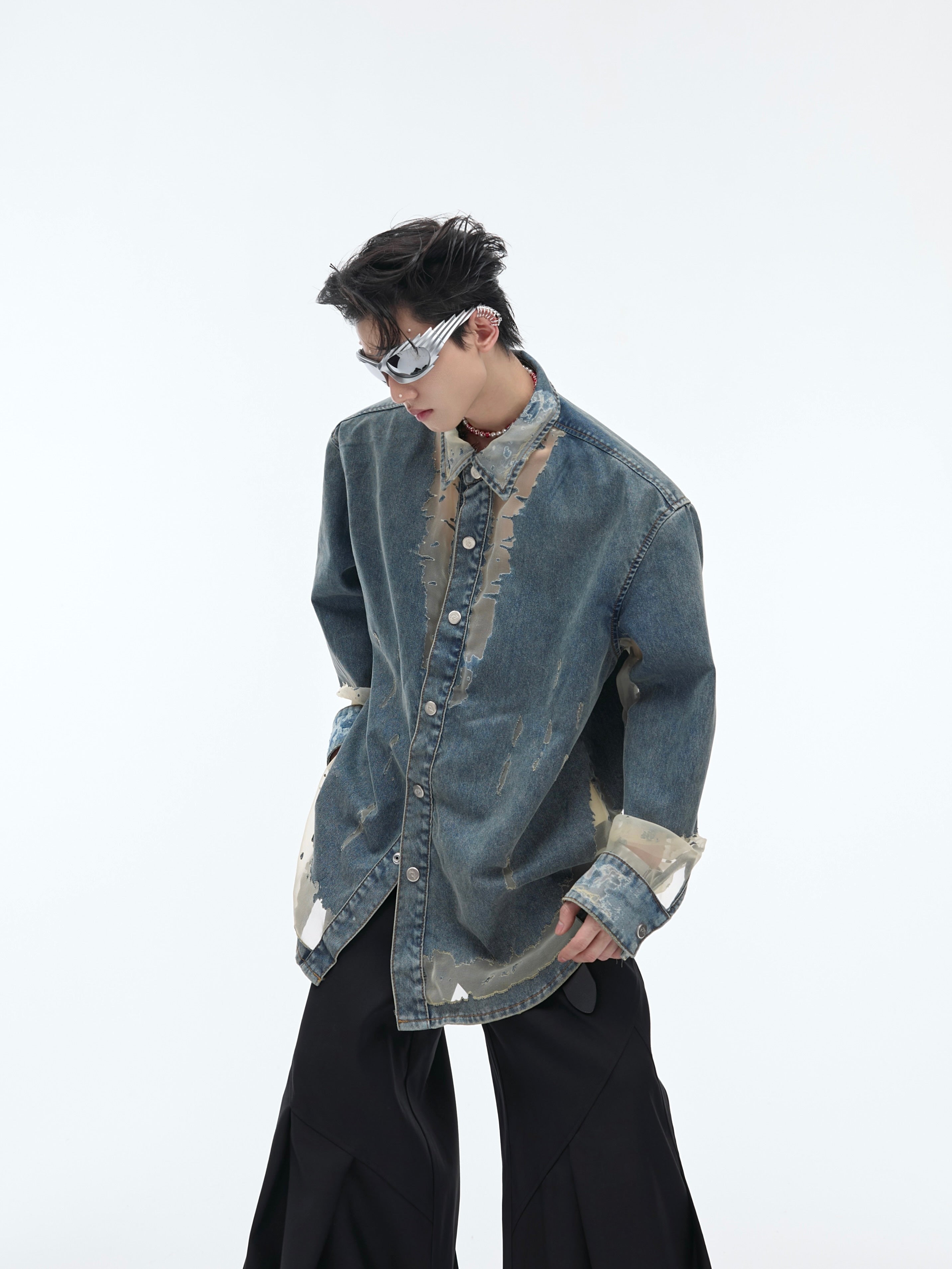 Close-up of raw edge detailing on this unique distressed denim shirt, featuring intentional cutouts for edgy street style
