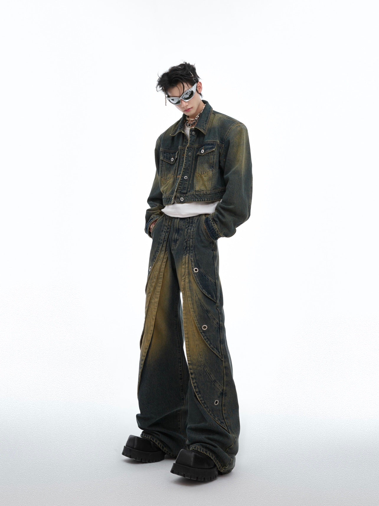 Side view showing the distinctive ring detail and deconstructed pocket design on these streetwear jeans