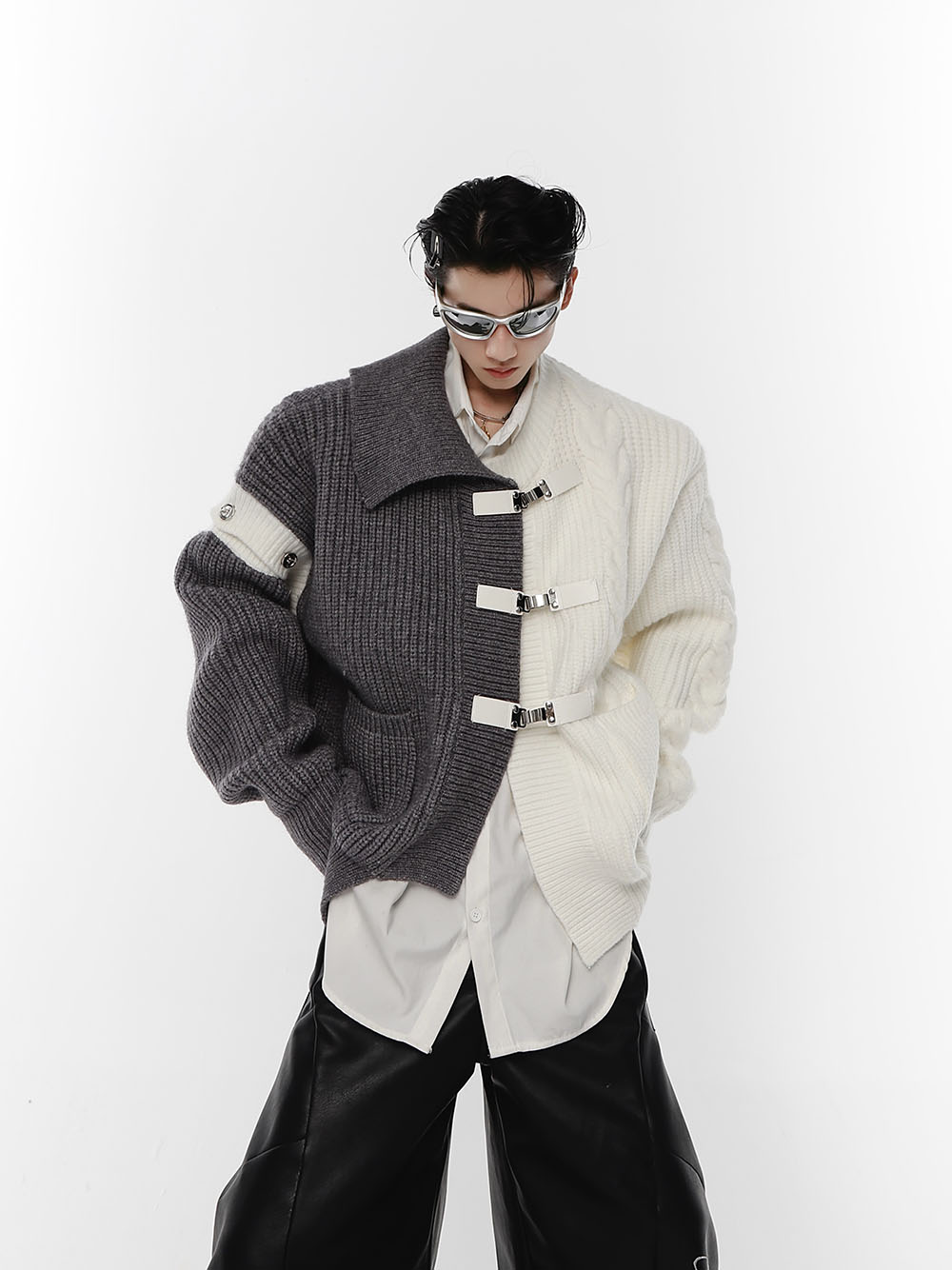 Black and white split oversized knit cardigan with metal buttons, showing avant-garde streetwear style