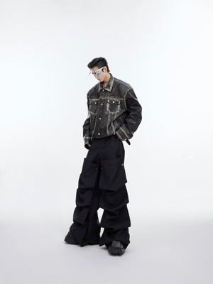 Back view of deconstructed leather jacket featuring striking split panel design with asymmetrical lines