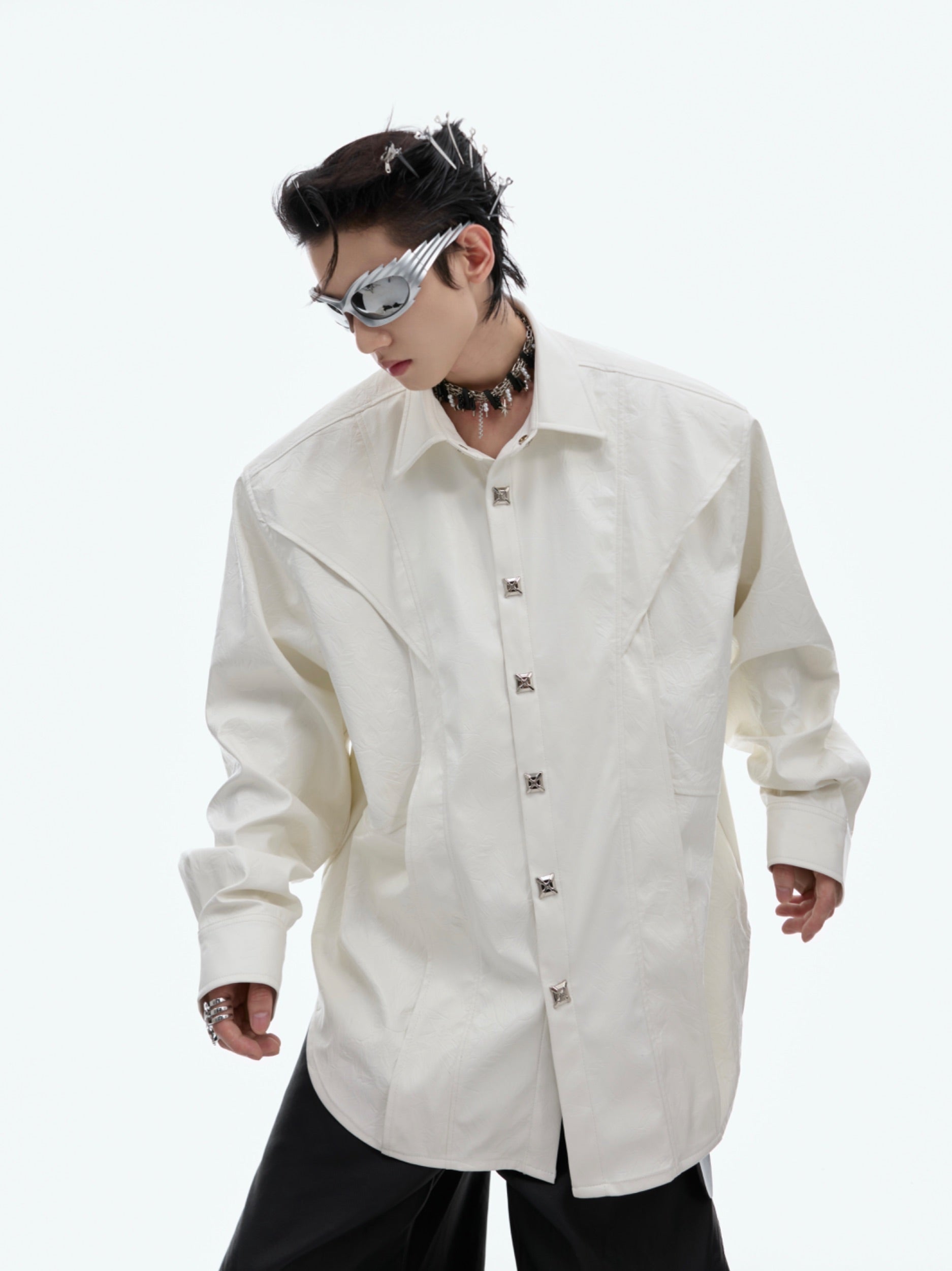 Edgy deconstructed long-sleeve shirt with metal buttons and shoulder pads, featuring glossy liquid effect texture