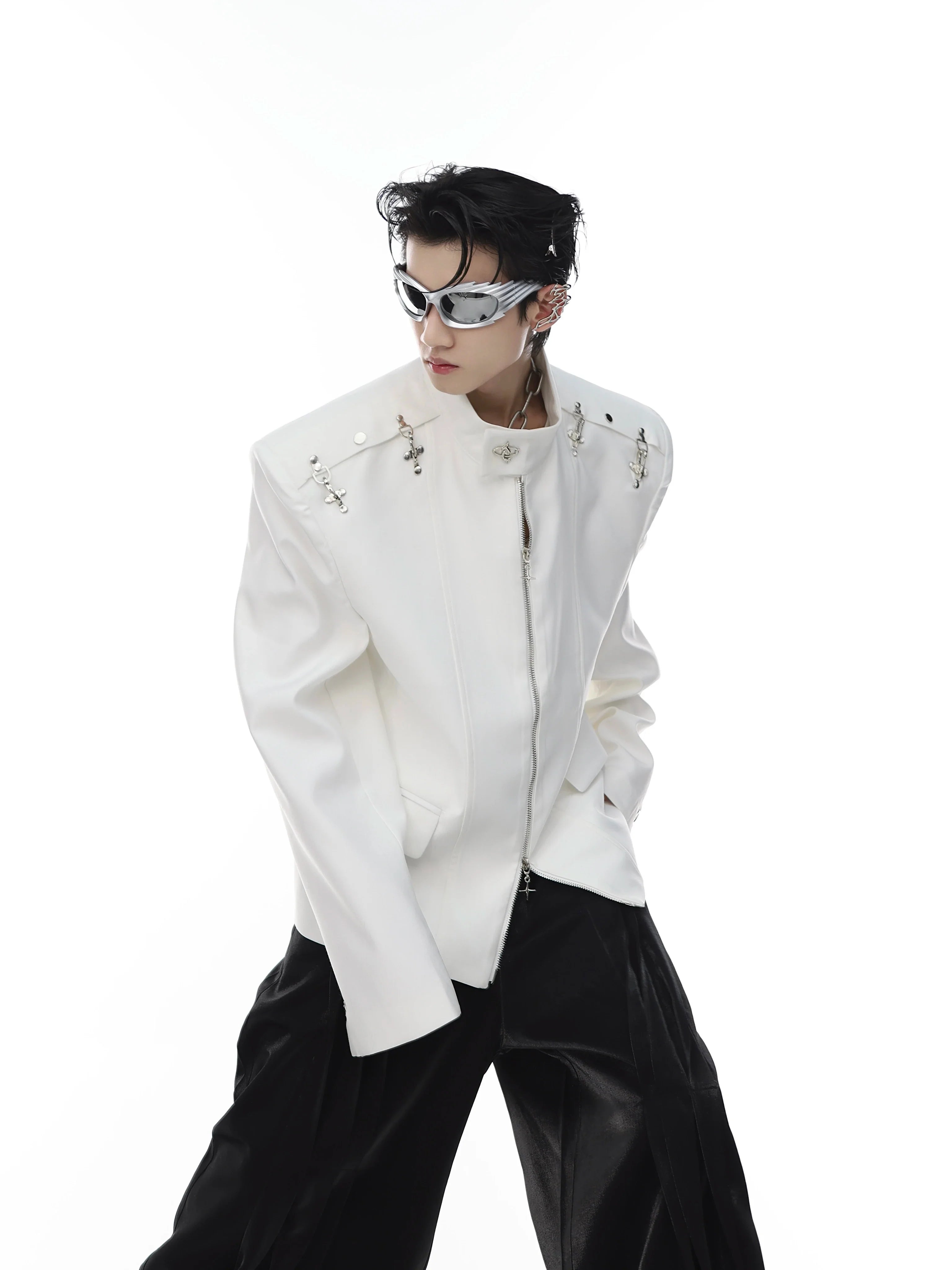 Front view of deconstructed blazer with metal clasp closure and high neck, featuring structured shoulder pads for edgy silhouette