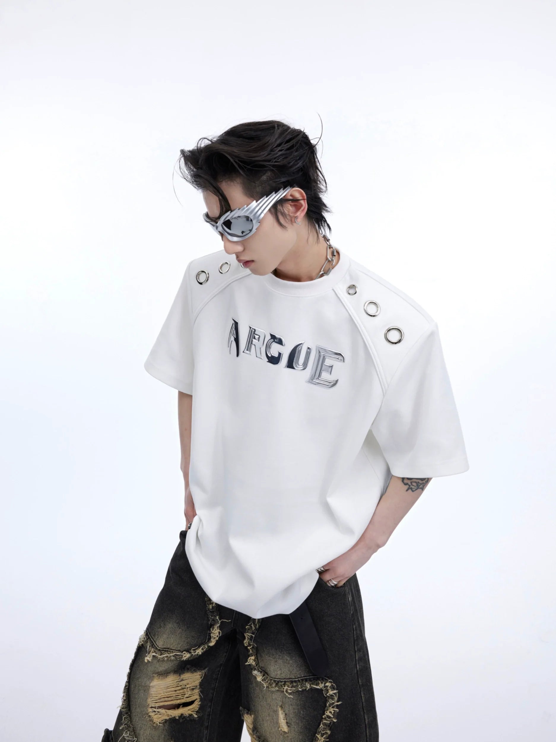 Front view of oversized deconstructed split tee featuring bold metal ring details and drop shoulder design