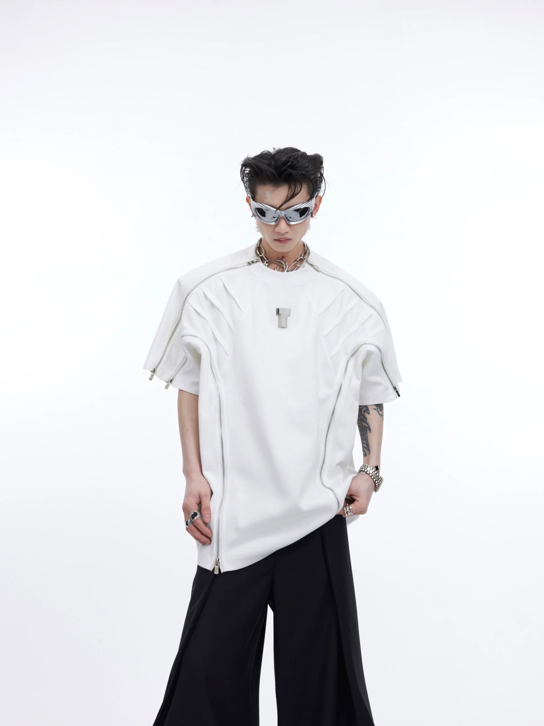 Front view of deconstructed oversized tee with metal zip detailing and textured fabric, showcasing urban streetwear style