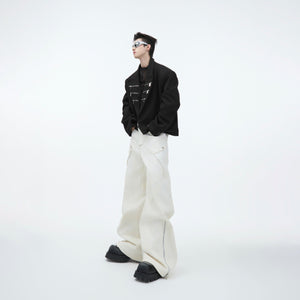 Close-up detail of dimensional fabric layers and stitching on these avant-garde cargo pants
