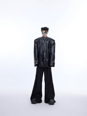 Side angle of deconstructed shiny leather jacket highlighting the unique textured segmentation and modern tailoring