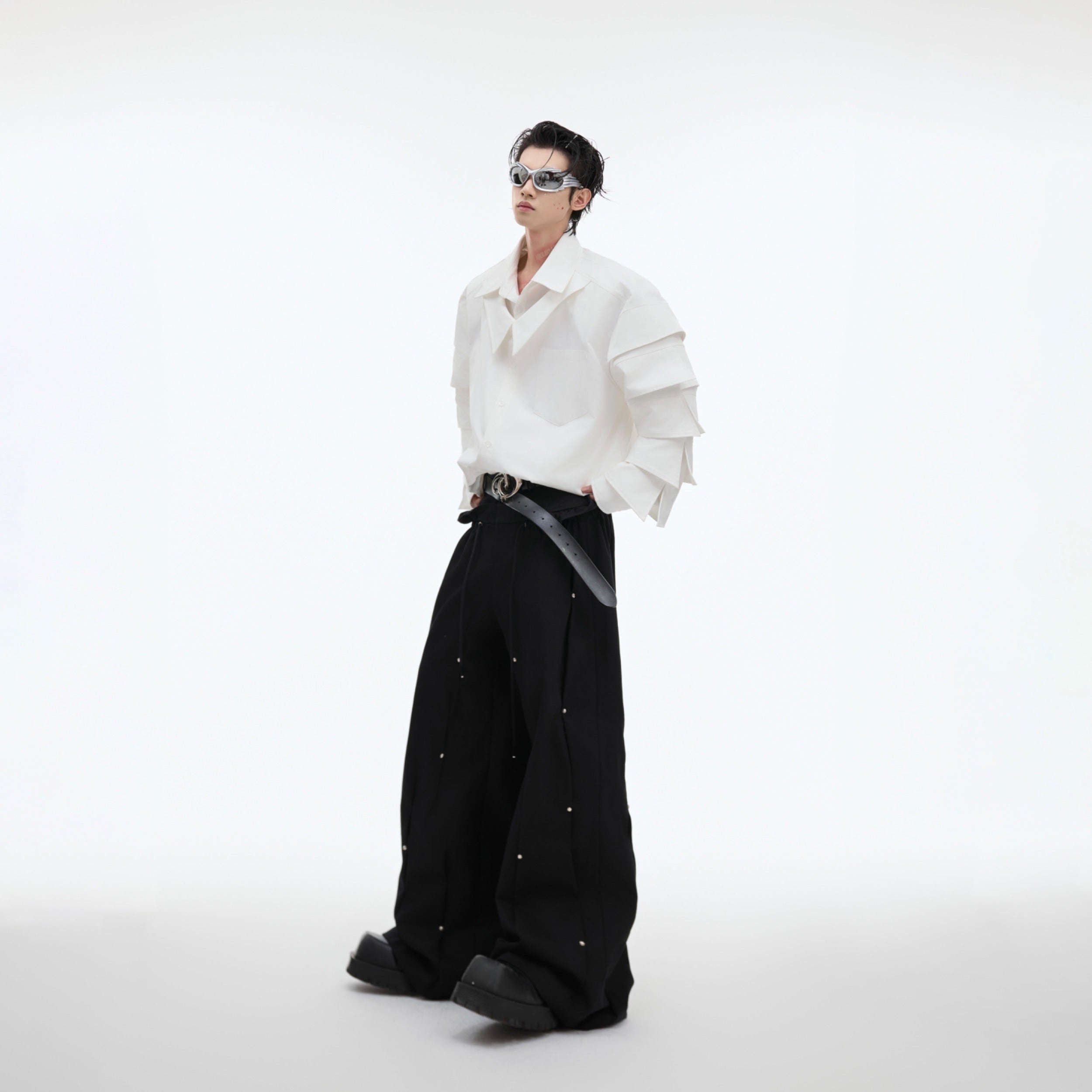 Side profile view of the avant-garde oversized shirt with unique structural elements