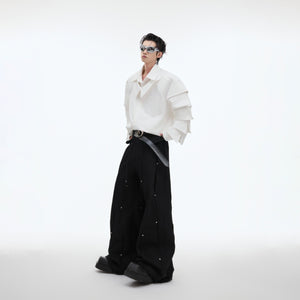 Side profile view of the avant-garde oversized shirt with unique structural elements
