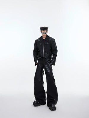 Front view of deconstructed shoulder-pad jacket with leather trim, showing unique patchwork design and urban style