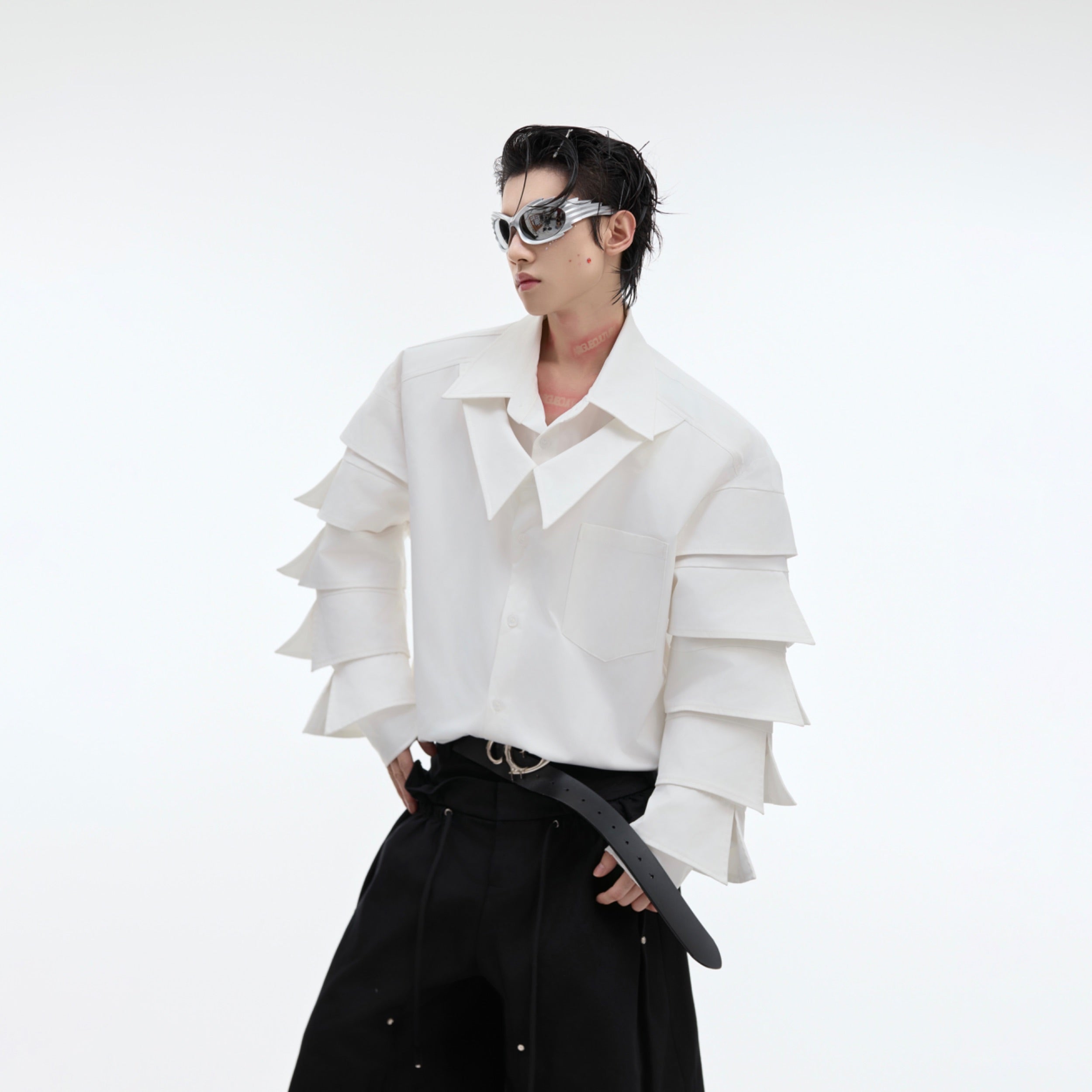 Front view of deconstructed shoulder-pad shirt showing pleated collar and oversized streetwear design
