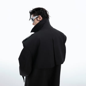Detailed view of the unique deconstructed shoulder pads on this statement trench coat