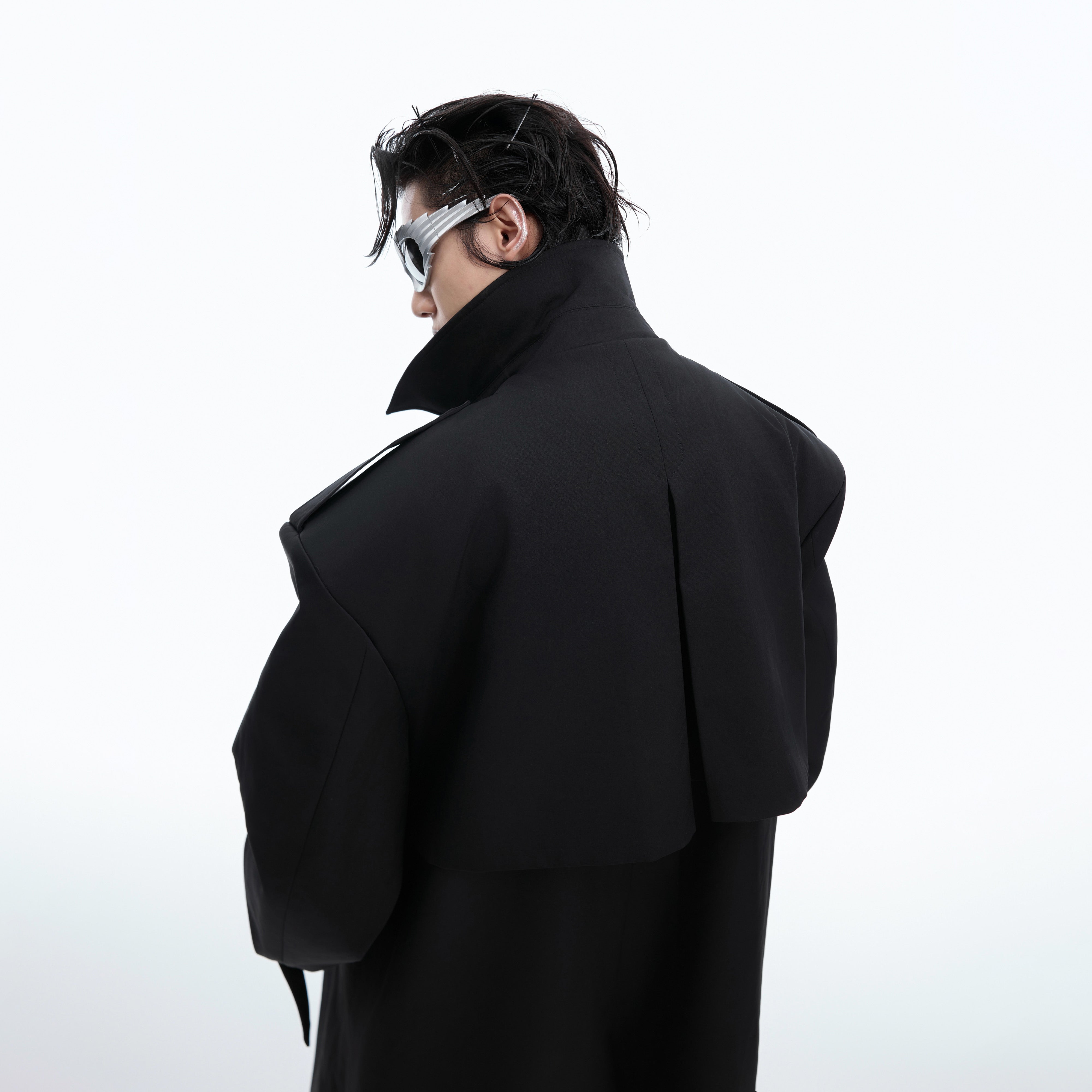Detailed view of the unique deconstructed shoulder pads on this statement trench coat